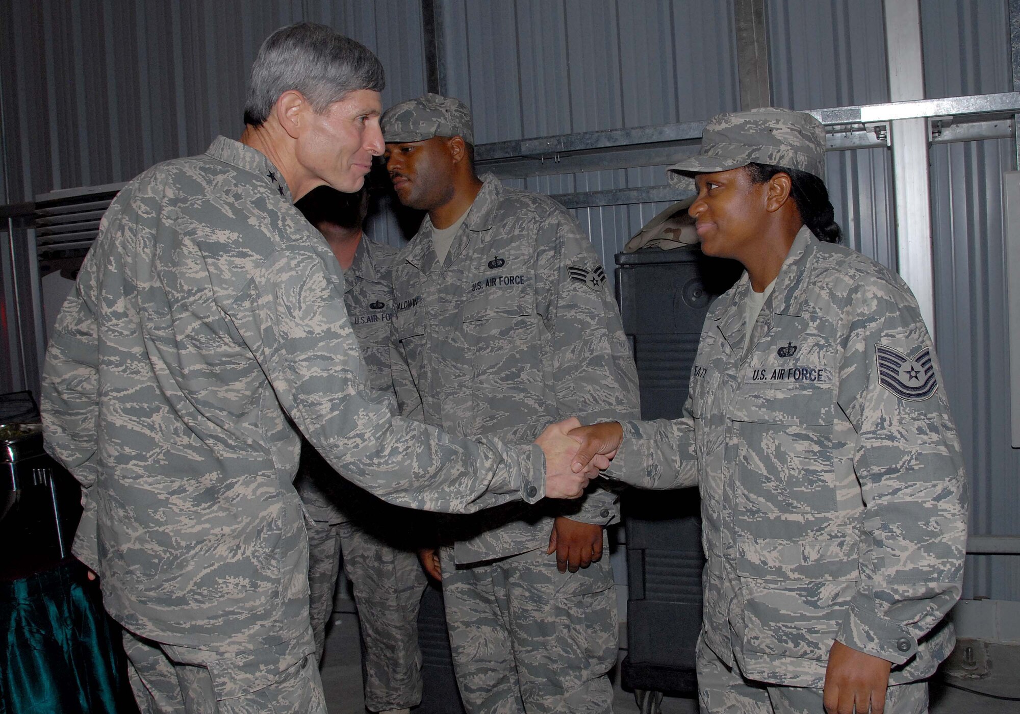 SOUTHWEST ASIA -- Chief of Staff of the Air Force, Gen. Norton Schwartz, thanks Tech. Sgt. Toni Beaty, a dining facility manager for the 380th Expeditionary Services Squadron, after a senior leader dinner here Oct. 22. (U.S. Air Force photo by Tech. Sgt. Denise Johnson/released)