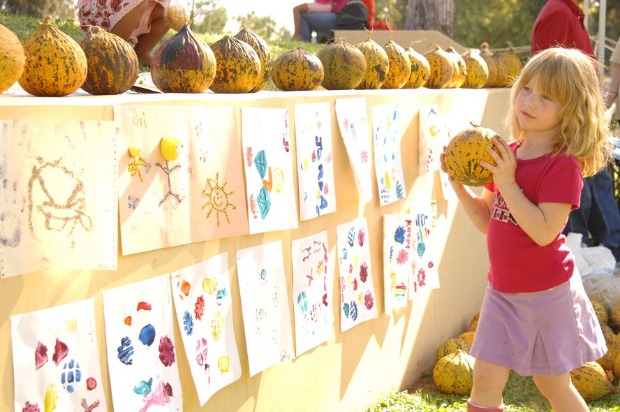 Erin McHugh sets her freshly painted pumpkin on the wall at Arkadas Park during this year’s Fall Festival. The festival was hosted by the 39th Force Support Squadron and included many family-oriented activities.