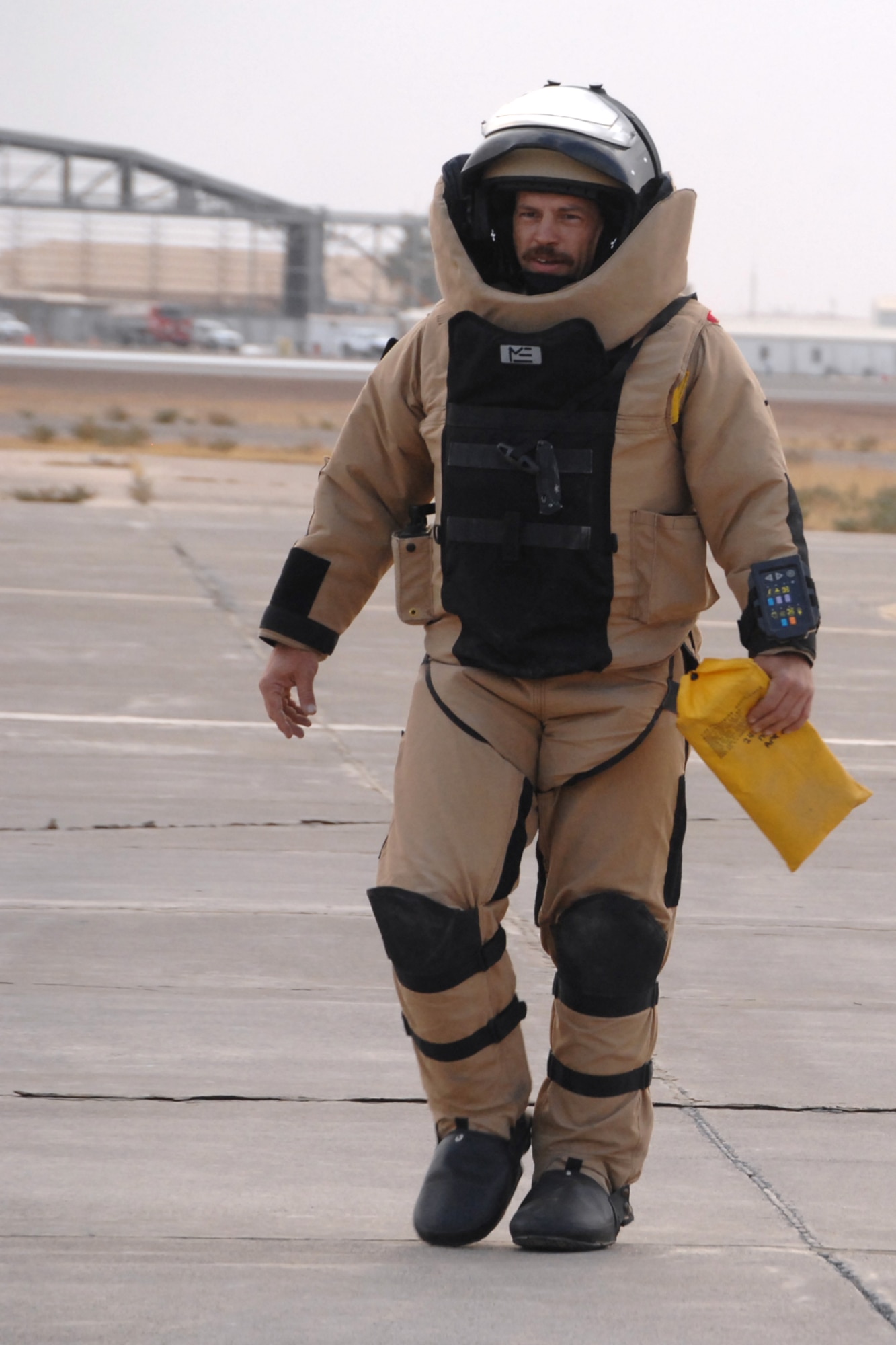 Tech. Sgt. Michael Shumate heads back from the runway in an Explosive Ordnance Disposal bomb suit after retrieving a suspicious package on the flightline at Kirkuk Regional Air Base, Iraq Oct. 21.  Sergeant Shumate and two other team members of the 506th Expeditionary Civil Engineer Squadron EOD responded to the call.  He is deployed from Whiteman AFB, Mo., and calls Winston-Salem, N.C., home. (U.S. Air Force photo/Senior Airman Randi Flaugh)