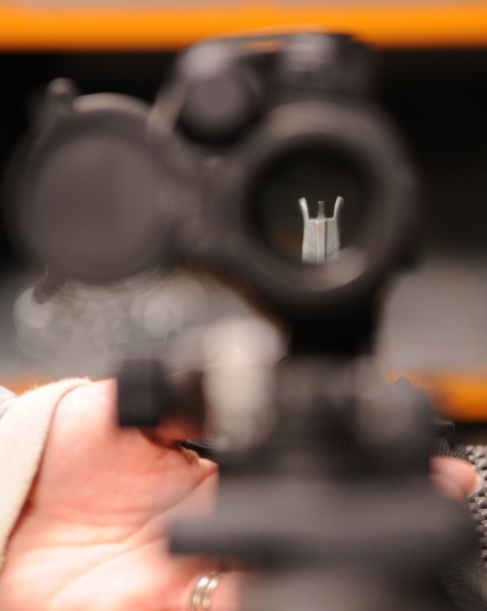 A first-person view looking down the scope of an M4 assault rifle at the armory at RAF Mildenhall, England, Oct. 21, 2008. All military members who own firearms are required to keep them stored at the armory. Additionally armorors issue and deploy government weapons to military members whose job requires them. (U.S. Air Force photo by Staff Sgt. Jerry Fleshman)