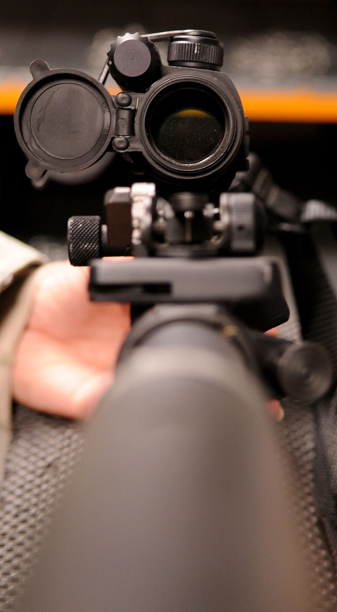 A first-person view looking down the scope of an M4 assault rifle at the armory at RAF Mildenhall, England, Oct. 21, 2008. All military members who own firearms are required to keep them stored at the armory. Additionally armorors issue and deploy government weapons to military members whose job requires them. (U.S. Air Force photo by Staff Sgt. Jerry Fleshman)