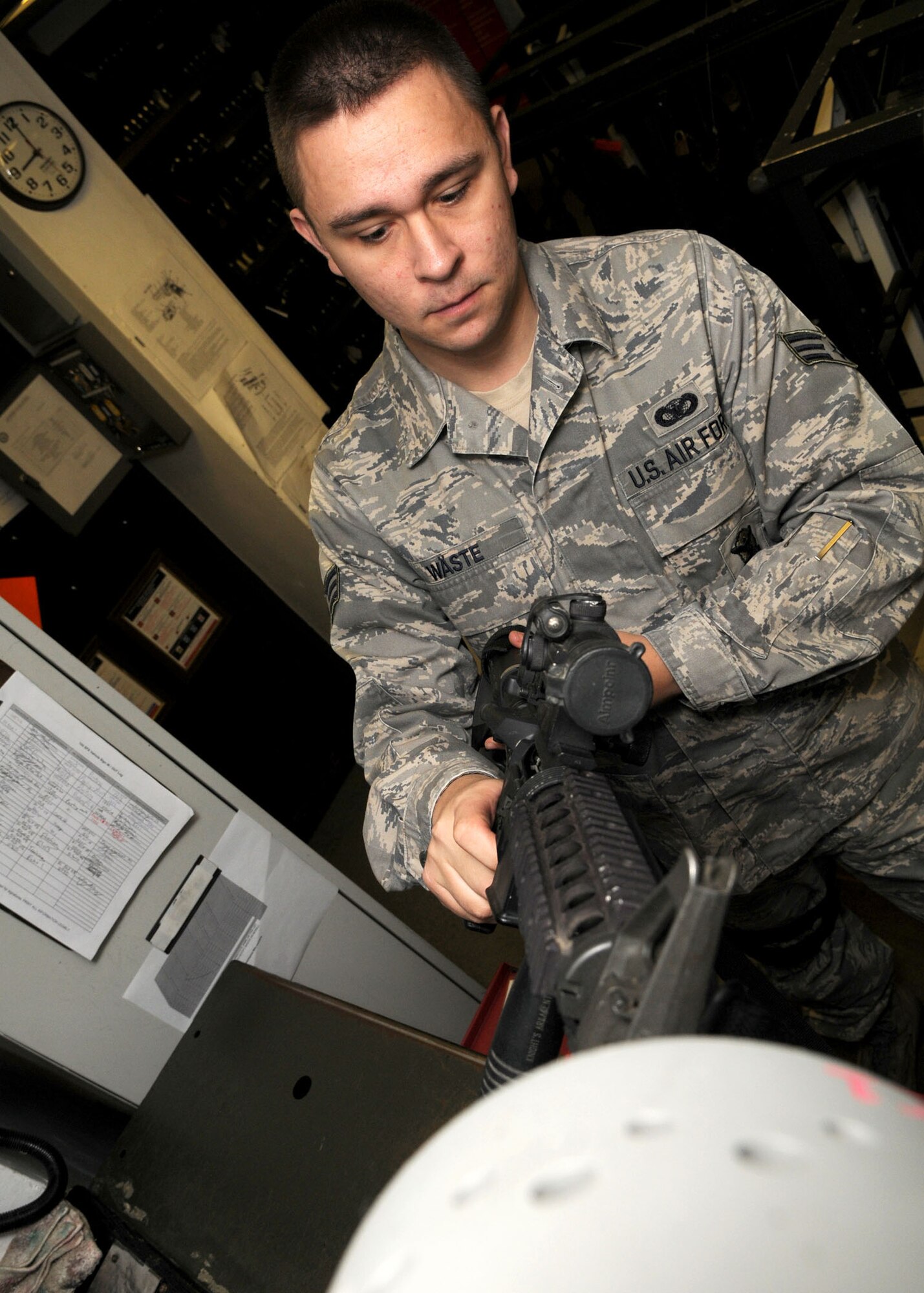 Senior Airman Johnnie Waste, a 100th Security Forces Squadron armorer, clears an M4 assault rifle before storing it at the armory at RAF Mildenhall, England, Oct. 21, 2008. All military members who own firearms are required to keep them stored at the armory.  Additionally they issue and deploy government weapons to military members whose job requires them, also performing routine inspections and basic maintenance. (U.S. Air Force photo by Staff Sgt. Jerry Fleshman) 