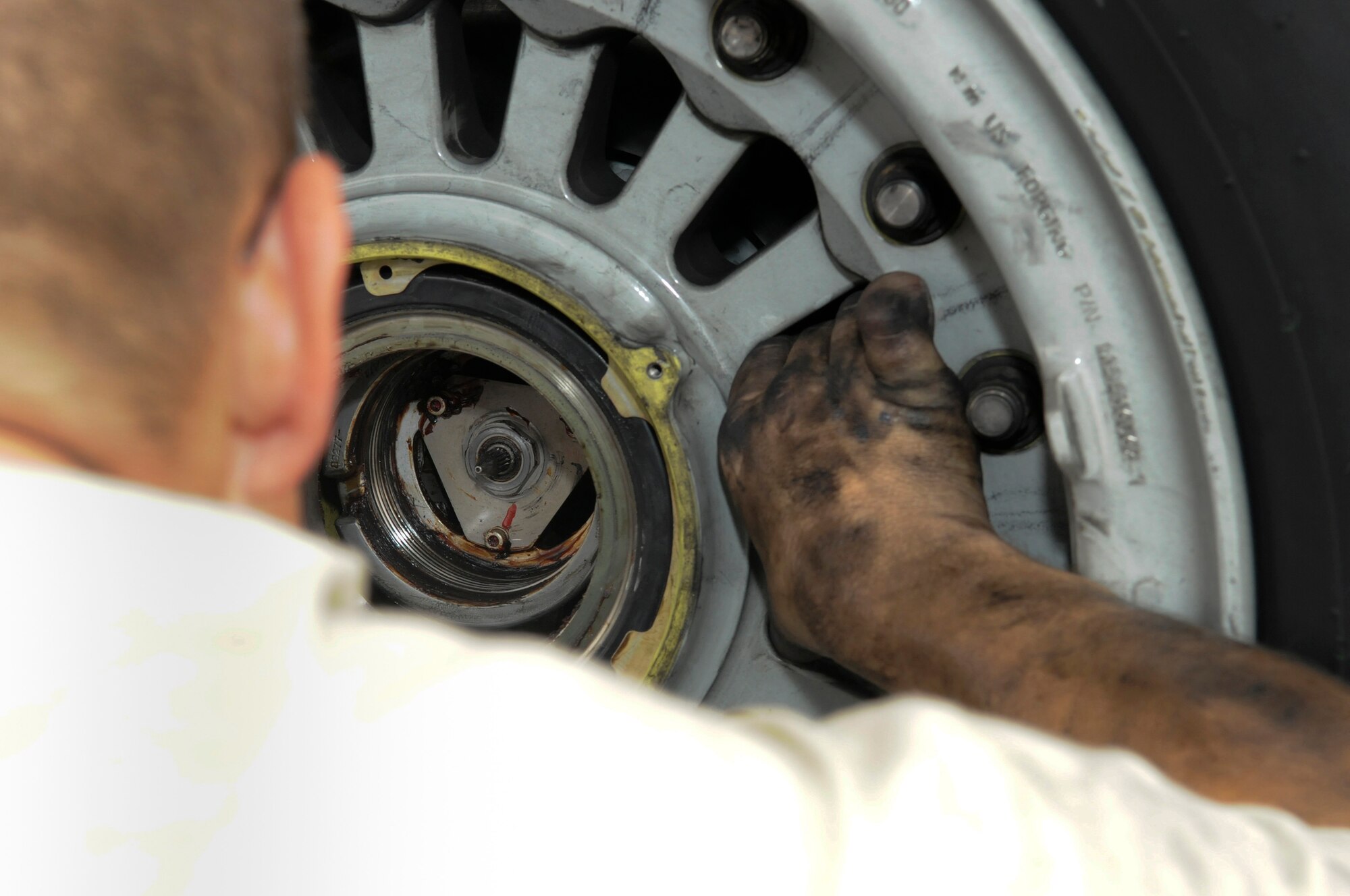 Airman 1st Class Cody Hickman, 8th Expeditionary Air Mobility Squadron, guides a wheel into place on a C-17 Globemaster III, October 23.    The wheel is the last step in the process of completing a brake change at an undisclosed air base in Southwest Asia. The C-17 is capable of rapid strategic delivery of troops and all types of cargo to main operating bases or directly to forward bases in the Central Command area of responsibility.  Airman Hickman is a native of Danbury, Texas, and is deployed from Charleston Air Force Base, S.C., in support of Operations Iraqi and Enduring Freedom and Joint Task Force-Horn of Africa.  (U.S. Air Force photo by Tech. Sgt. Michael Boquette/Released)