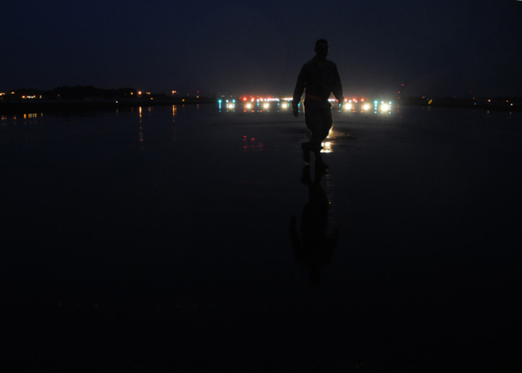 Airman 1st Class Robert Evans, airfield management operations coordinator, double verifies a spot on the runway isn’t foreign object debris. The Airmen in his organization inspect the runway, taxiways and flightline every morning before aircraft use it. They’re looking for FOD, standing water and surface water. While they’re out and about they also keep an eye out for birds or other wildlife that could present a hazard to flying operations here. Airman Evans is a native of Deltona, Fla. (U.S. Air Force photo by Staff Sgt. Nathan Gallahan)