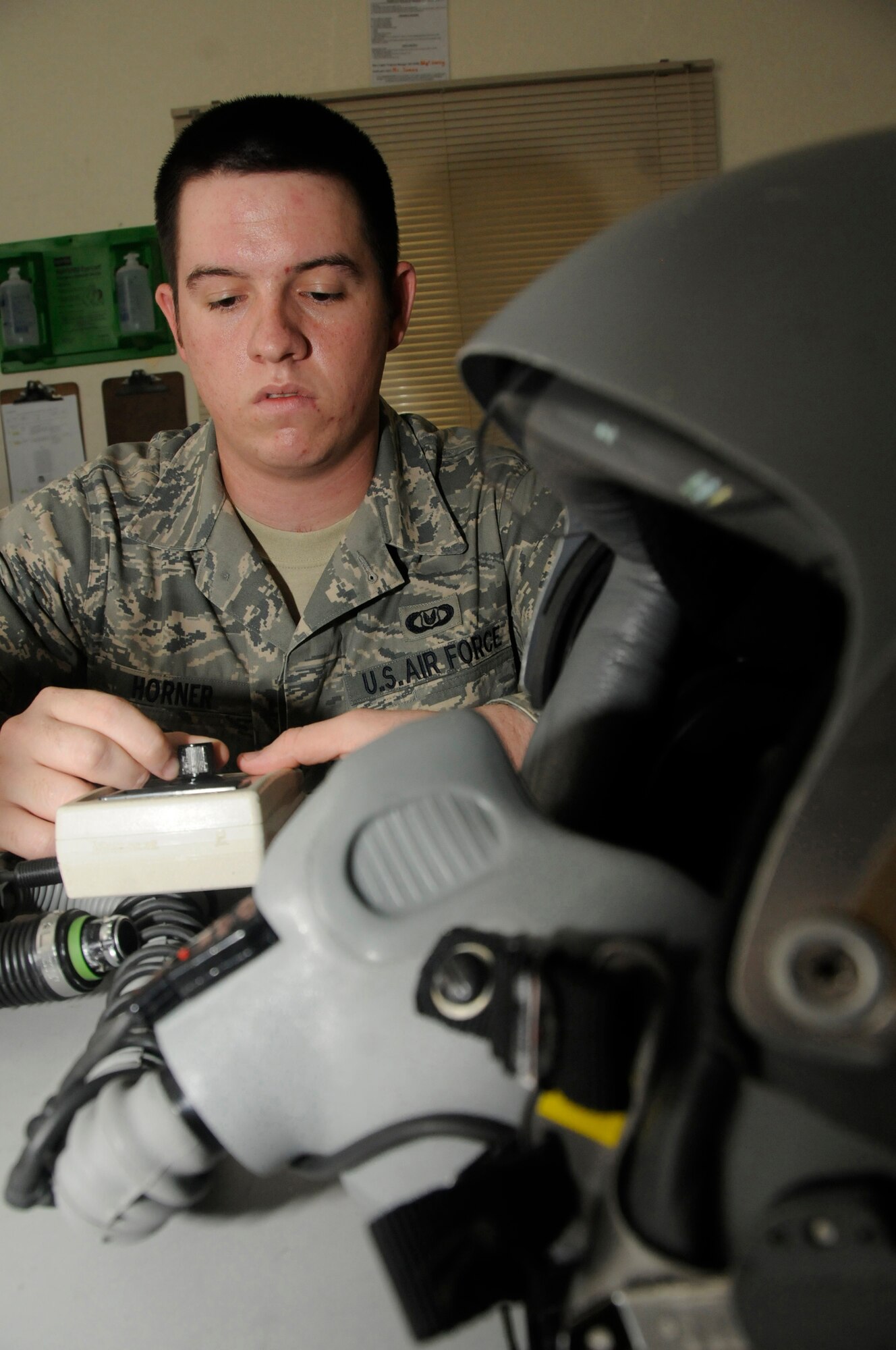 Airman 1st Class Ryan Horner, aircrew flight equipment technician assigned to the 379th Expeditionary Operations Support Squadron, uses test equipment to perform a functional check of a HG55P flight helmet Oct. 23, 2008, at an undisclosed air base in Southwest Asia.  Airman Horner, a native of San Antonio, Texas, is deployed from MacDill Air Force Base, Fla., in support of Operations Iraqi and Enduring Freedom and Joint Task Force-Horn of Africa. (U.S. Air Force photo by Staff Sgt. Darnell T. Cannady/Released)