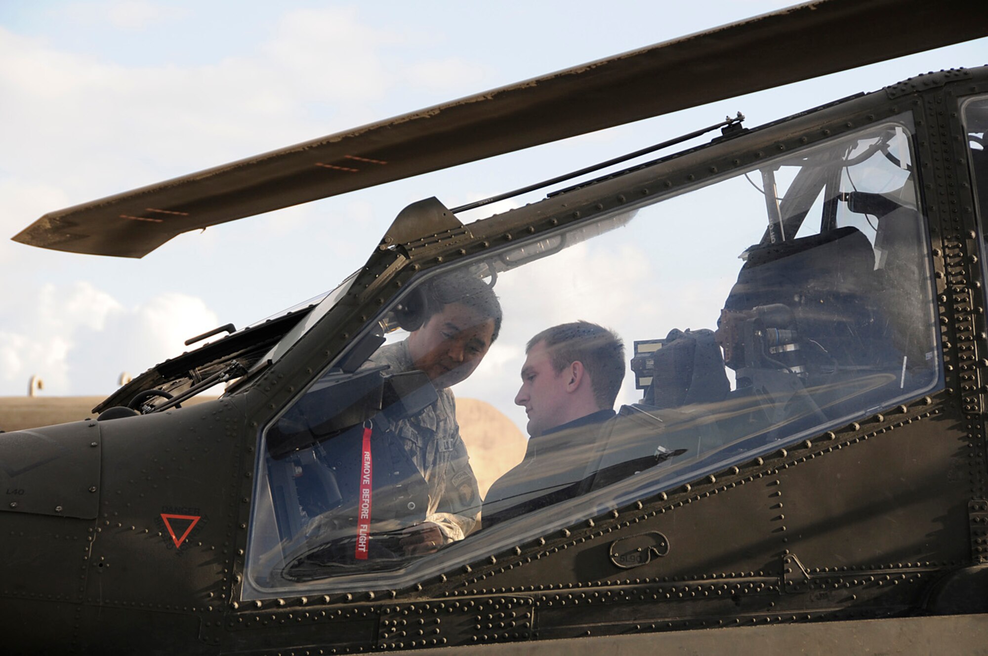 U.S. Army Maj. Lee Fennema explains the capabilities of a WAH-64 Apache to Royal Air Force personnel at RAF Lakenheath, England, Oct. 22. Major Fennema was part of a dual-sided show and tell about the Apache and HH-60G Pave Hawk helicopters.(U.S. Air Force photo by Senior Airman Brian J. Ellis)