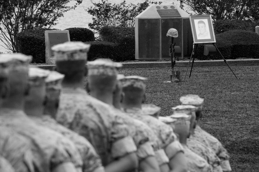 Marines from 1st Battalion, 6th Marine Regiment, 24th Marine Expeditionary Unit, remembered 1st Lt. Jason Mann, platoon commander, and Cpl William Cooper, scout sniper, in a ceremony Oct. 24. They both died during the unit's seven-month deployment to southern Afghanistan. Mann received a Navy Commendation Medal with a Combat Valor attachment. Cooper received a Bronze Star with a Combat Valor attachment for his leadership and actions against the ambushing Taliban fighters who eventually took his life. (Official Marine Corps photograph by Sgt. Randall A. Clinton) ::r::::n::::r::::n::