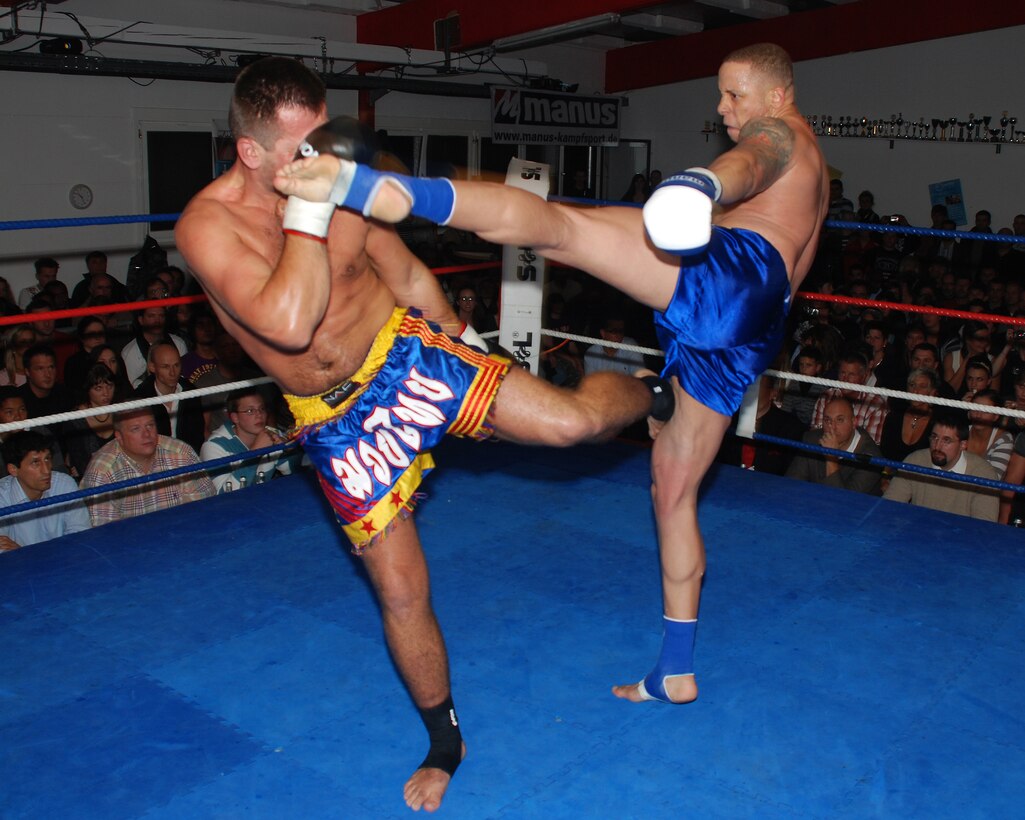 Cpl. Micah C. Terry (right), a guard force Marine with Marine Forces Europe, kicks his opponent, Silyevic Yasmin, in the head during the Mettler Fight Night in Leinfelden-Echterdingen, Germany. Terry defeated his opponent by unanimous decision, winning all three rounds of the Muay Thai kickboxing match.