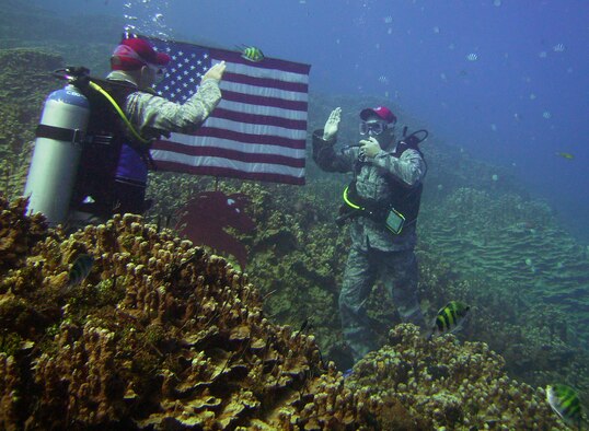 ANDERSEN AIR FORCE BASE, Guam - Lt. Col. Anthony Davit, 554th RED HORSE Squadron commander, administers the oath of enlistment to Master Sgt. Chad Craig, 554th RHS electrician, Oct. 23 at 25 feet underwater off COMNAVMAR’s Gab Gab beach.  (Photo courtesy of 554th RHS)