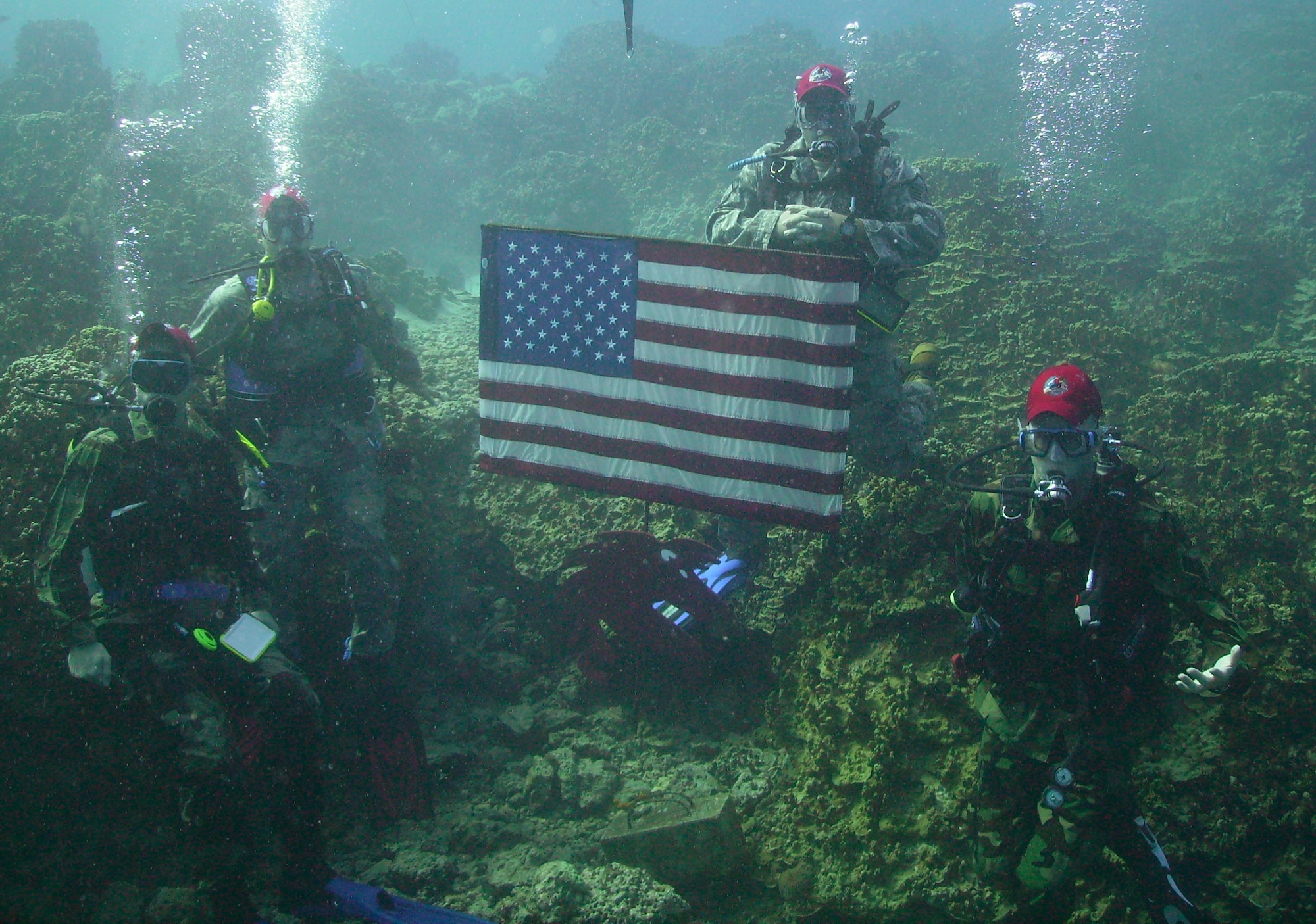 ANDERSEN AIR FORCE BASE, Guam - Following an underwater reenlistment ceremony, Capt. Brian Ellis, Lt. Col. Anthony David, Master Sgt. Chad Craig and Staff Sgt. Stephen Johnson pose for pictures.  The reenlistment ceremony was held Oct. 23 at COMNAVMAR's Gab Gab beach.  (Photo courtesy of 554th RHS)