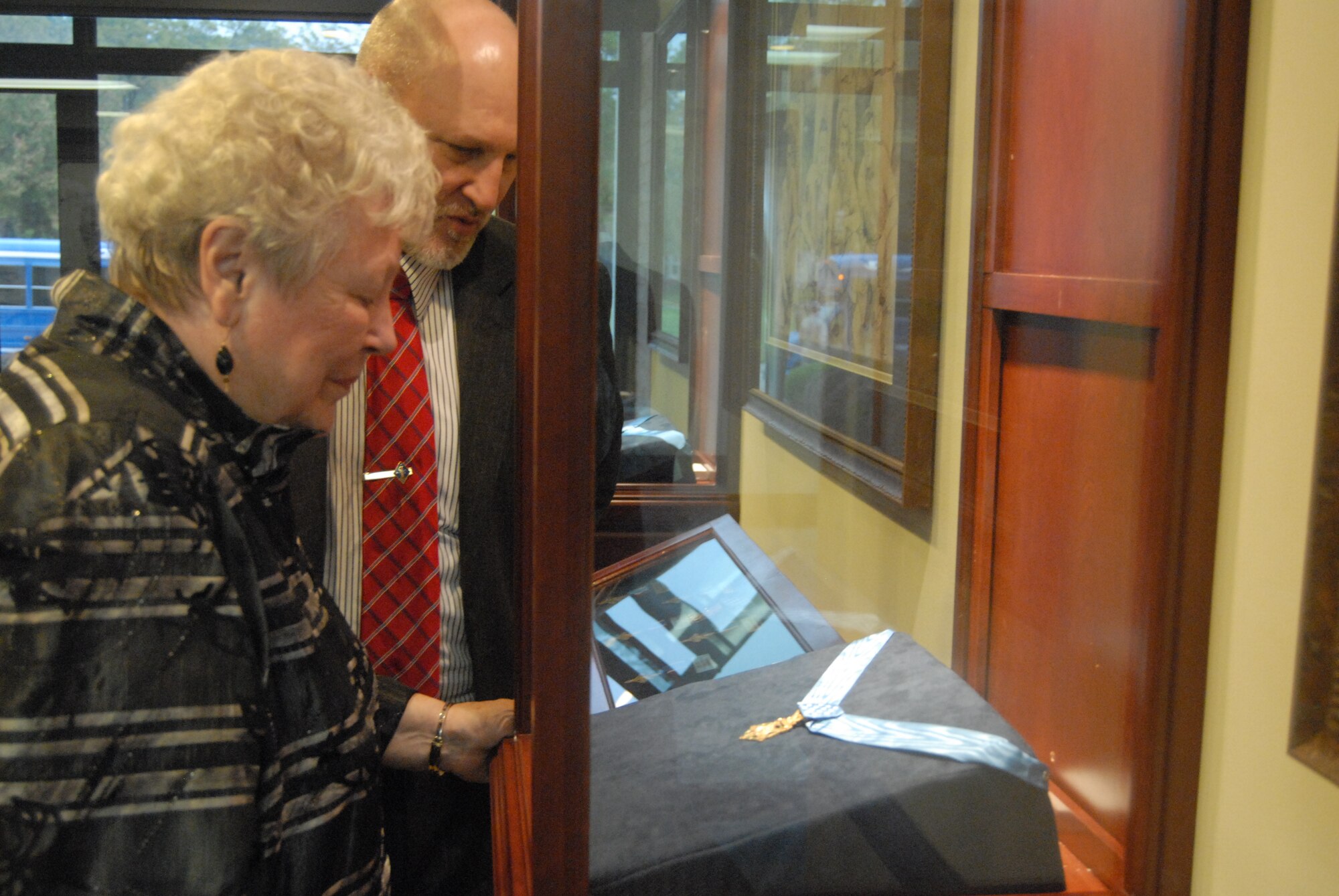 Barbara Zeamer, surviving widow of Lt. Col. Jay Zeamer Jr., and Keith Alexander, 43rd Airlift Wing Historian, view a Medal of Honor in the Heritage Hall Oct. 17 similar to the one awarded to her late husband. (U.S. Air Force Photo by Staff Sgt. Jon LaDue) 