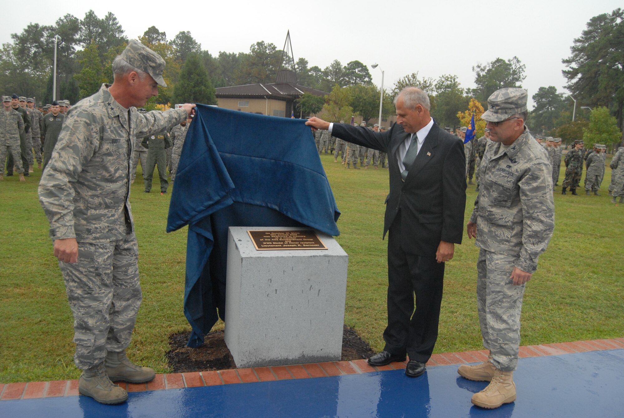 Maj. Gen. Winfield Scott III, 18th Air Force Commander, and Jim Rembisz, nephew of Lt. Joseph R. Sarnoski, along with Col. John McDonald, 43rd Airlift Wing Commander, unveil the monument at the newly dedicated Lt. Joseph Sarnoski Parade Field during a ceremony Oct. 17. (U.S. Air Force Photo by Staff Sgt. Jon LaDue) 