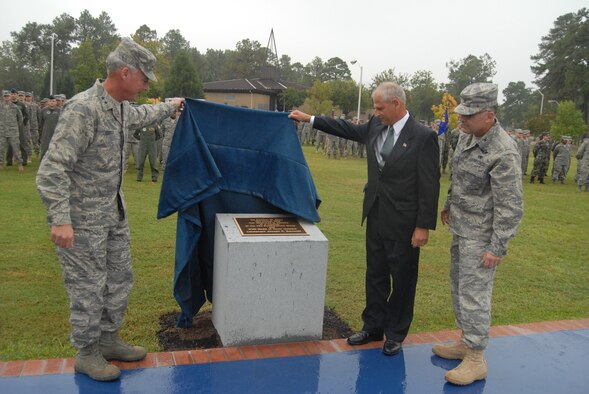 Maj. Gen. Winfield Scott III, 18th Air Force Commander, and Jim Rembisz, nephew of Lt. Joseph R. Sarnoski, along with Col. John McDonald, 43rd Airlift Wing Commander, unveil the monument at the newly dedicated Lt. Joseph Sarnoski Parade Field during a ceremony Oct. 17. (U.S. Air Force Photo by Staff Sgt. Jon LaDue) 