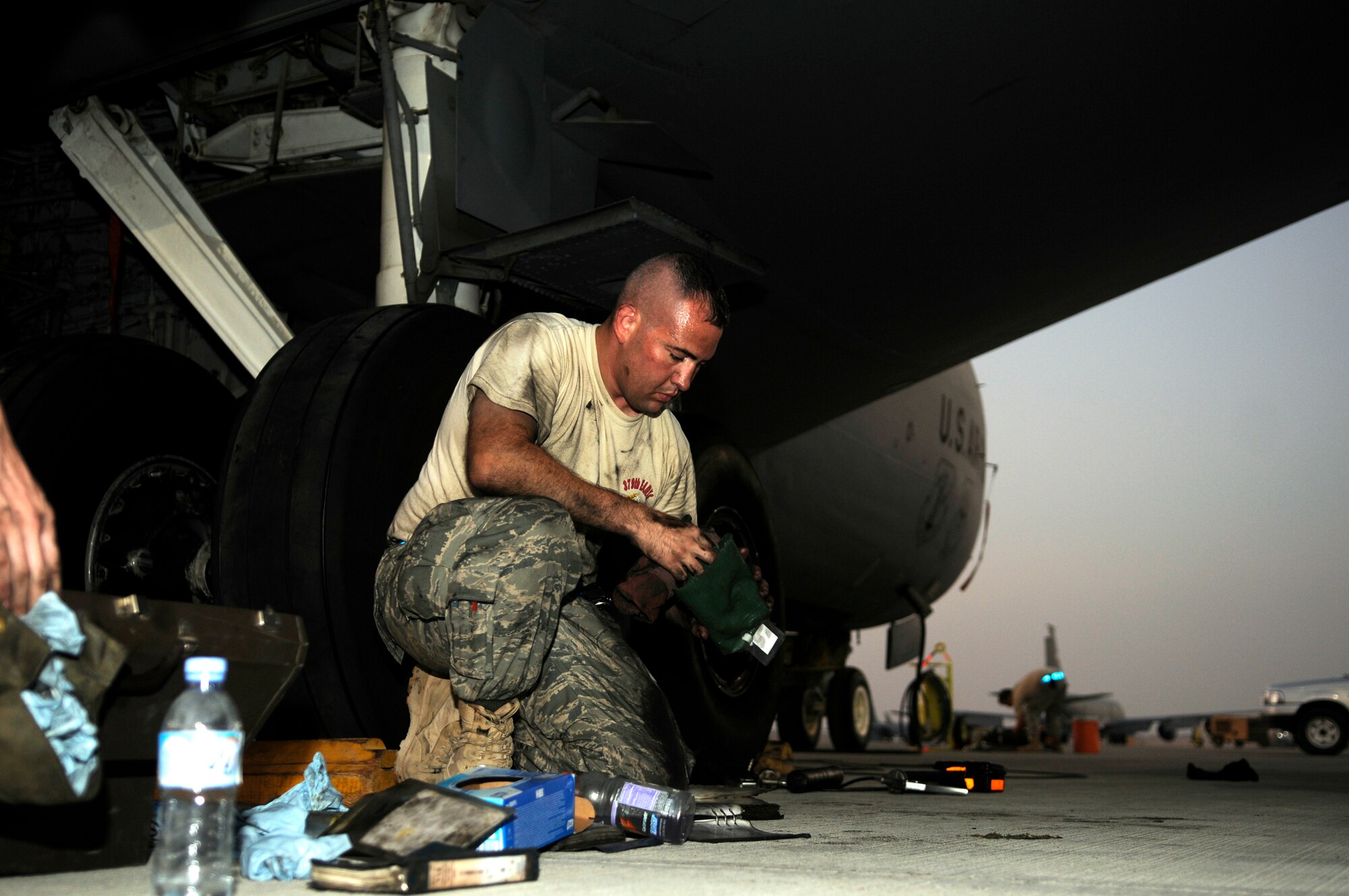 Staff Sgt. Eric Mutschlechner assigned to the 379th Aircraft Maintenance Squadron, 340th Aircraft Maintenance Unit, stuffs dirty rags back into a bag, accounting for each equipment item brought to the aircraft, October 24, 2008, at an undisclosed air base in Southwest Asia.  Sergeant Mutschlechner is cleaning up after completing a brake change on a KC-135 Stratotanker.  The KC-135 Stratotanker provides the core aerial refueling capability for the United States Air Force and provides aerial refueling support to Navy and Marine Corps and allied nation aircraft operating in the Central Command area of responsibility.  Sergeant Mutschlechner is a native of San Marcos, Texas and deployed from MacDill Air Force Base, Fla., supporting Operations Iraqi and Enduring Freedom and Joint Task Force-Horn of Africa.  (U.S. Air Force photo by Tech. Sgt. Michael Boquette/Released)