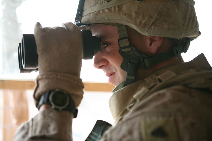 Lance Cpl. Ron Groshong (center), a machine gunner, and Lance Cpl. Jose Pacheco, a motor transport operator, both with 3rd Squad, Provisional Rifle Platoon 3, Regimental Combat Team 5, secure the front of a home in Rawah, Iraq, Oct. 27. The Marines of 3rd Squad were responsible for the security of the area around the south banks of the Euphrates River near the Rawah Bridge and Traffic Control Point 4.::r::::n::