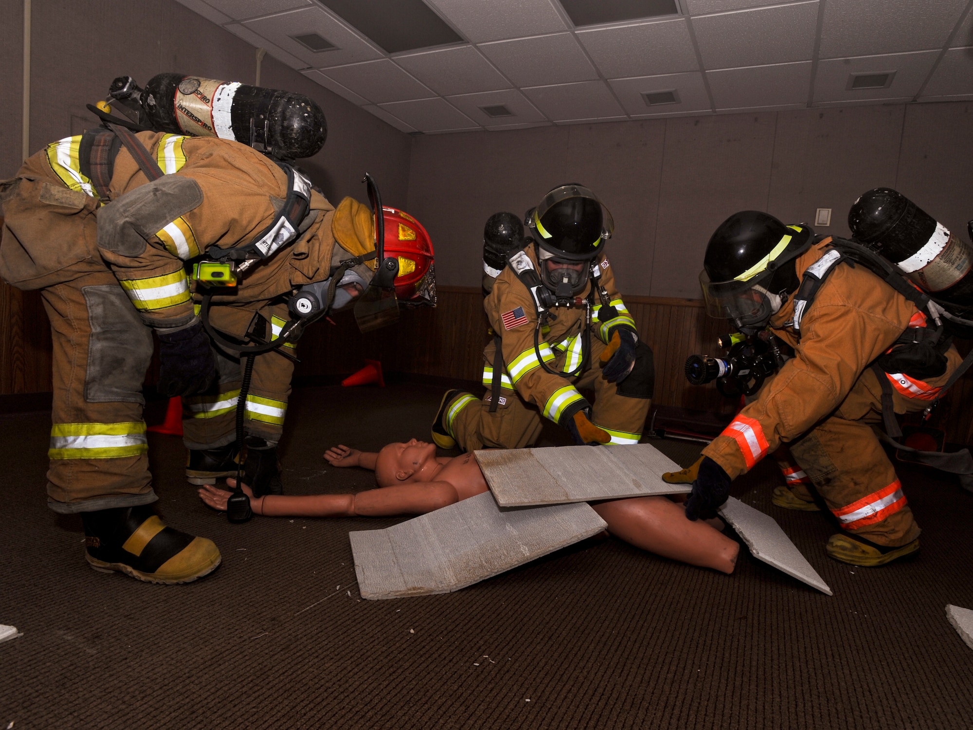 ELMENDORF AIR FORCE BASE Alaska -- Fire fighters from the 3rd Civil Engineer Squadron, locate and rescue a "victim" during the Emergency Management Exercise here Oct. 27. The EME allows Elmendorf Airmen to practice their rescue skills for possible real-life crisis situations. (U.S. Air Force photo/Staff Sgt. Joshua Garcia)