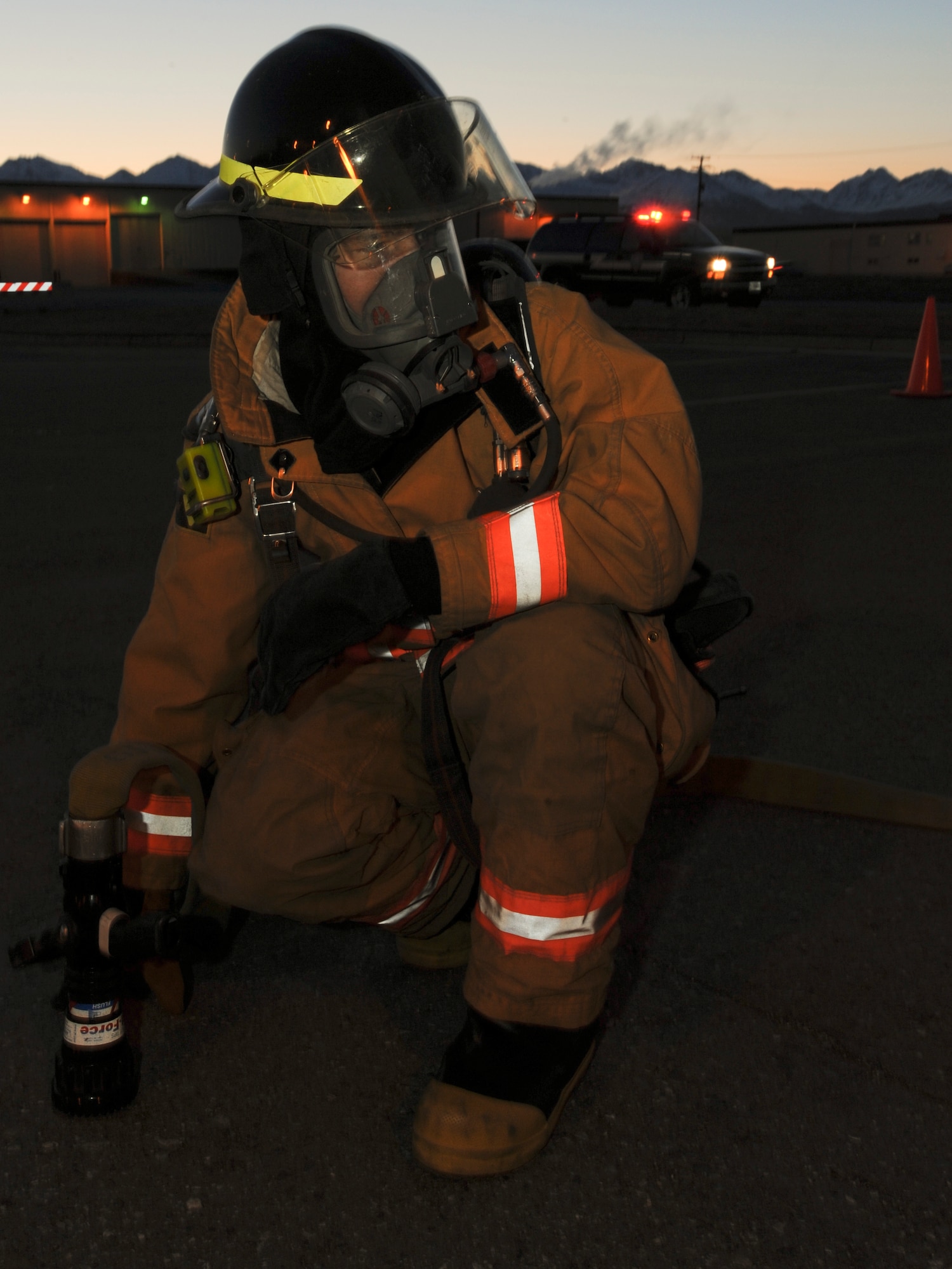 ELMENDORF AIR FORCE BASE Alaska -- Airman 1st Class Brett Dykema, a 3rd Civil Engineer Squadron fire fighter, watches the perimeter of a building during the Emergency Management Exercise here Oct. 27. The building is continually monitored to ensure that no secondary fires start. (U.S. Air Force photo/Staff Sgt. Joshua Garcia)