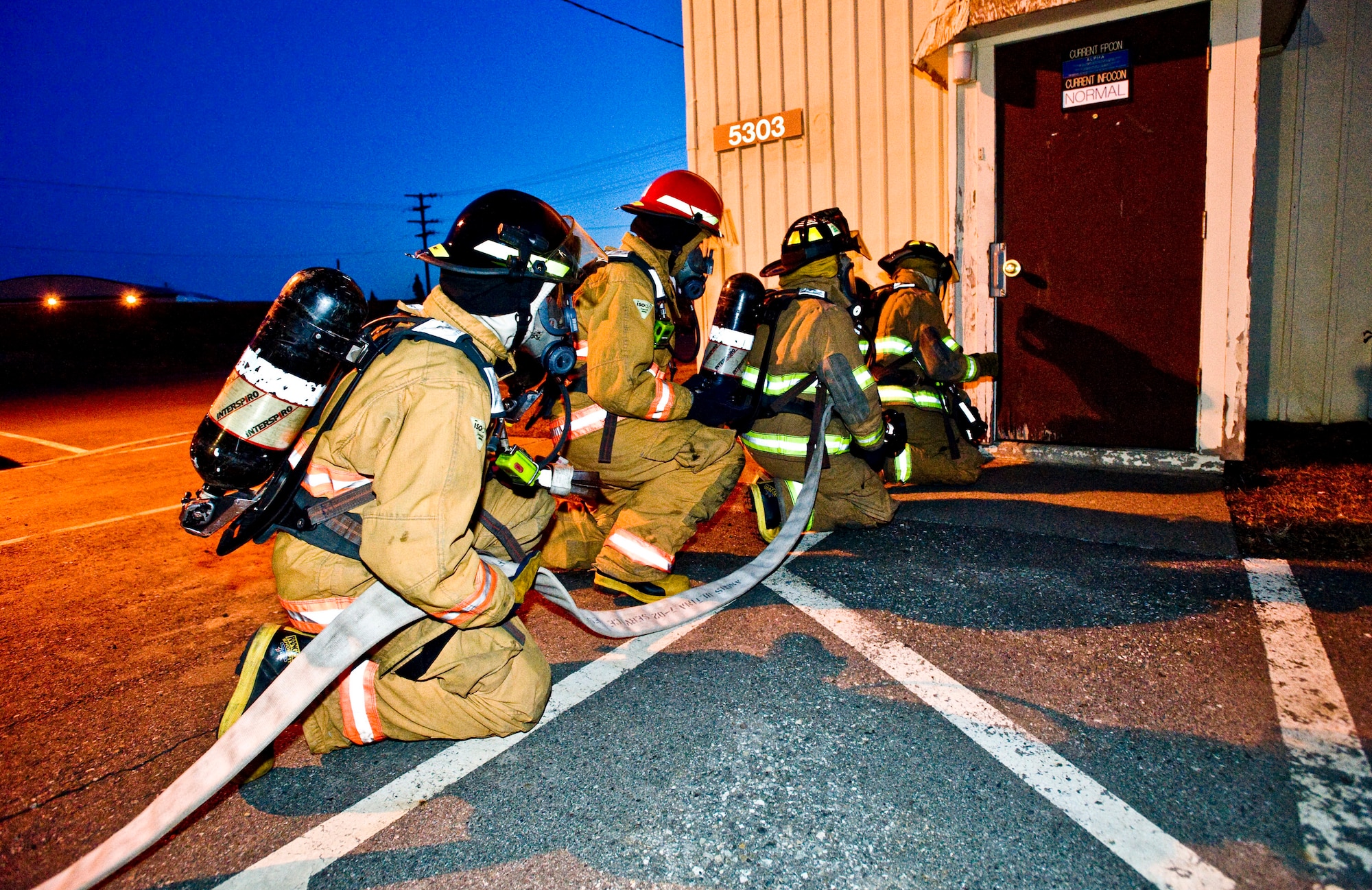 ELMENDORF AIR FORCE BASE, Alaska -- Fire fighters from 3rd Civil Engineer Squadron prepare to enter a building for a fire drill Oct. 16. The fire fighters were responding to a fire after a mock earthquake. (U.S. Air Force photo/Senior Airman Jonathan Steffen)