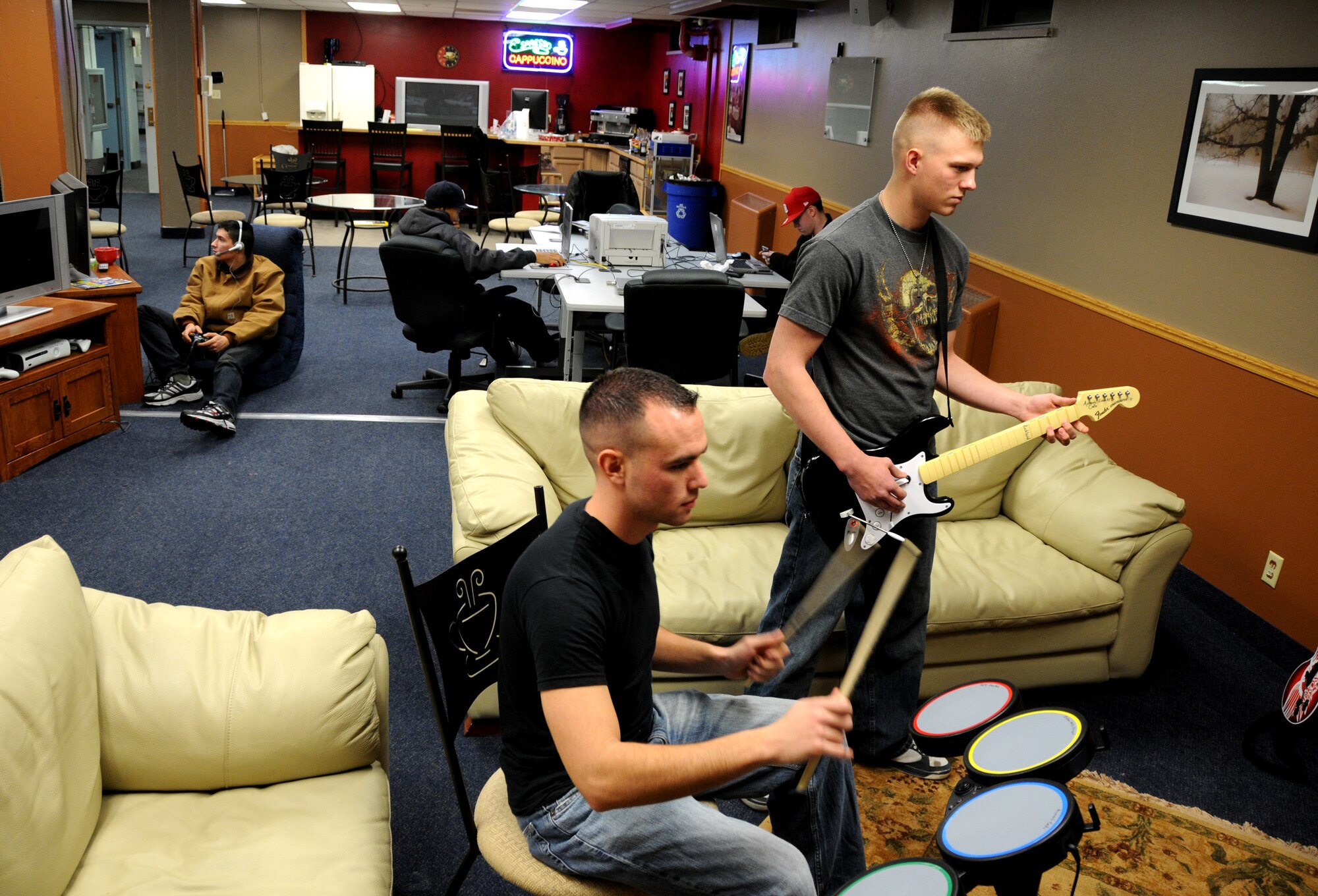 Airman 1st Class Tyler Baressi and Airman 1st Class Dan Parish-Olson play Rock Band at North Star Cafe Oct.25, 2008 at Eielson Air Force Base, Alaska. The cafe is funded by the chapel and provides several types of video games, Wi-Fi, pool tables, and cable TV free to single and unaccompanied Airmen. (U.S. Air Force photo/Airman Laura Max) 