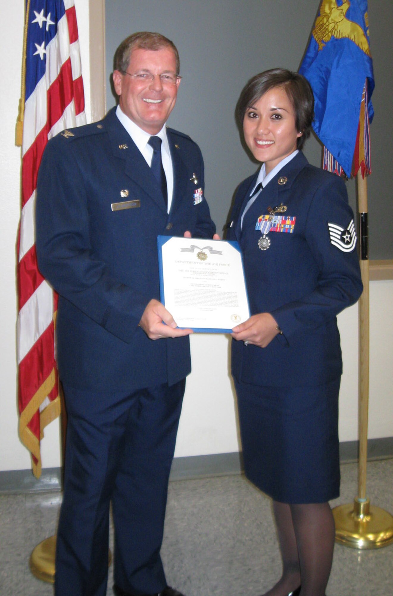 Col. David Culbertson (left), 926th Group Commander, presents Tech. Sgt. MaryAnn Martin, 706th Fighter Squadron, Noncommissioned Officer in Charge of Aviation Resource Management, with an Achievement Medal during Commander's Call on Oct. 25.