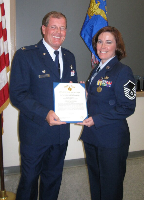 Master Sgt. Barbara Tarvin, 926th Group Career Advisor, receives a Commendation Medal during Commander's Call on Oct. 25.