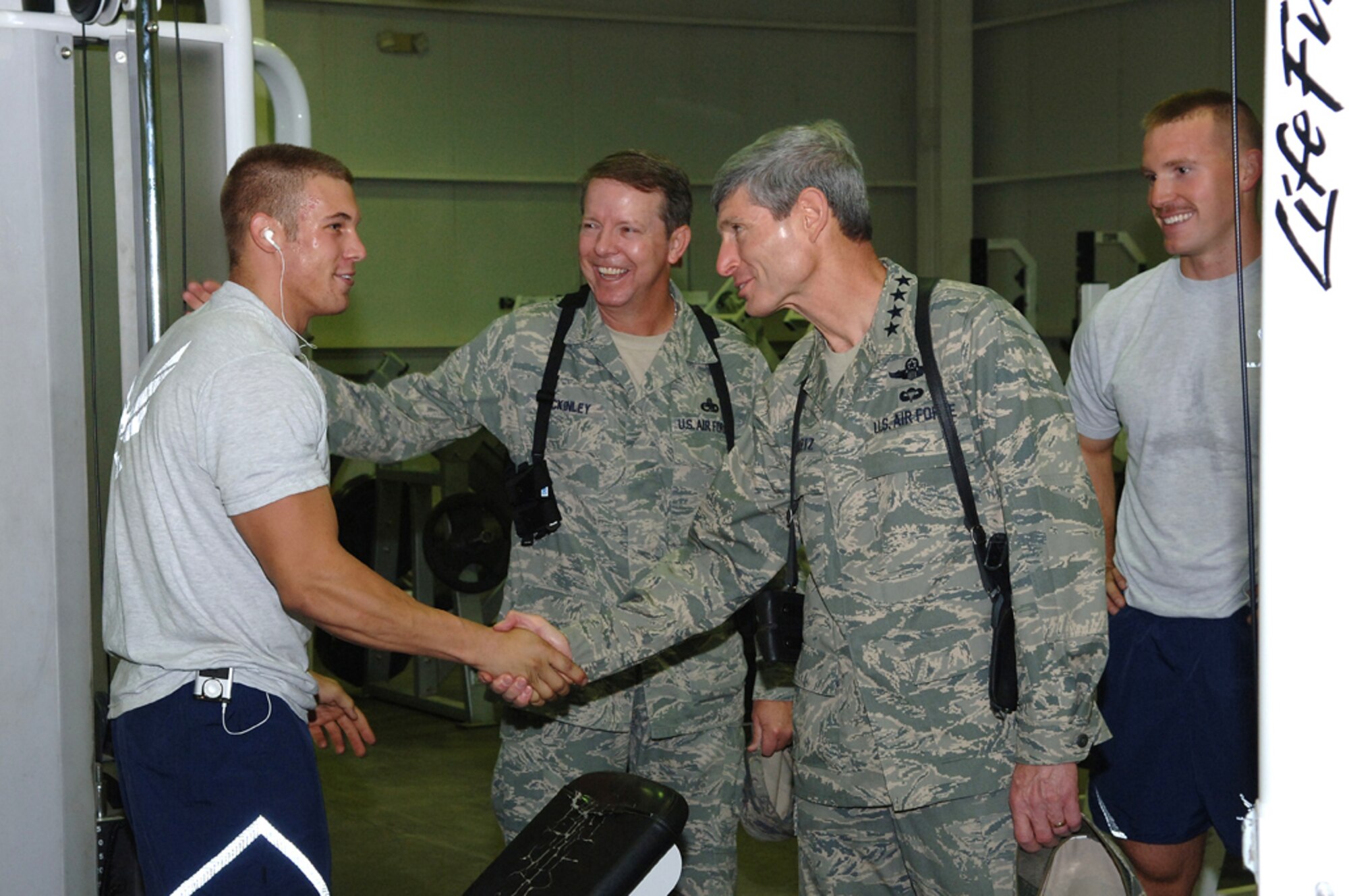 Air Force Chief of Staff Gen. Norton Schwartz and Chief Master Sgt. of the Air Force Rodney McKinley congratulate an Airman for his dedication to fitness during a tour of the Red Tail Fitness Center at Joint Base Balad, Iraq, Oct. 25. General Schwartz and Chief McKinley visited eight installations throughout the U.S. Central Command area of responsibility and the Horn of Africa. (U.S. Air Force photo/Tech. Sgt. Richard Lisum)
