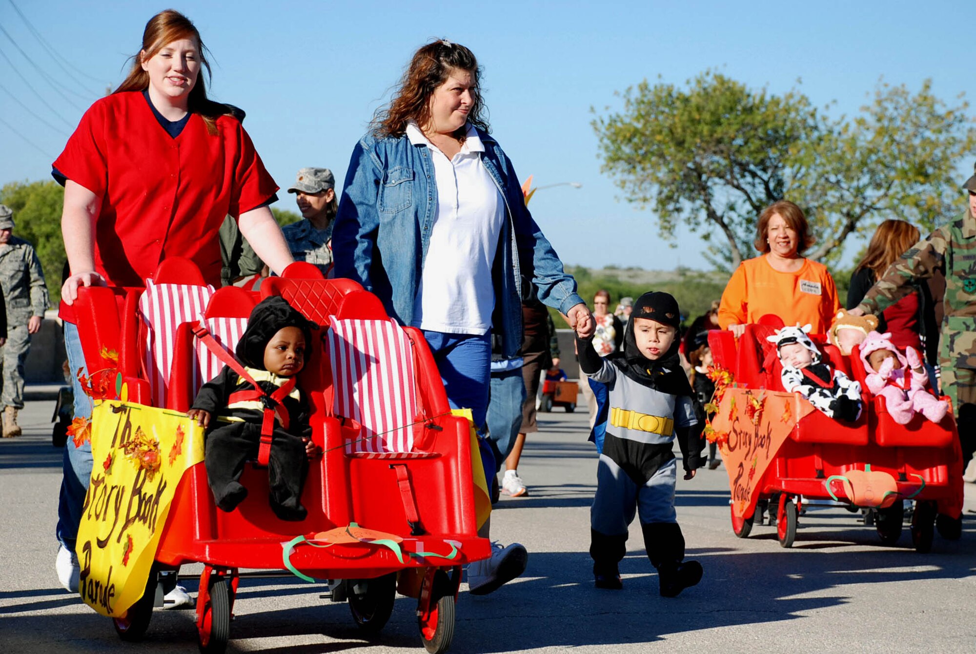 LAUGHLIN AIR FORCE BASE, Texas – Laughlin parents walk with their children around Ribas-Dominicci Circle for the Child Development Center's Storybook Parade to celebrate literacy Oct. 24. Throughout the month, the children listened to stories and were then asked to come dressed as their favorite character for a parade. Costumes ranged from Spiderman to Dr. Seuss characters and other creative outfits. (U.S. Air force photo by Airman 1st Class Saar Csurilla)