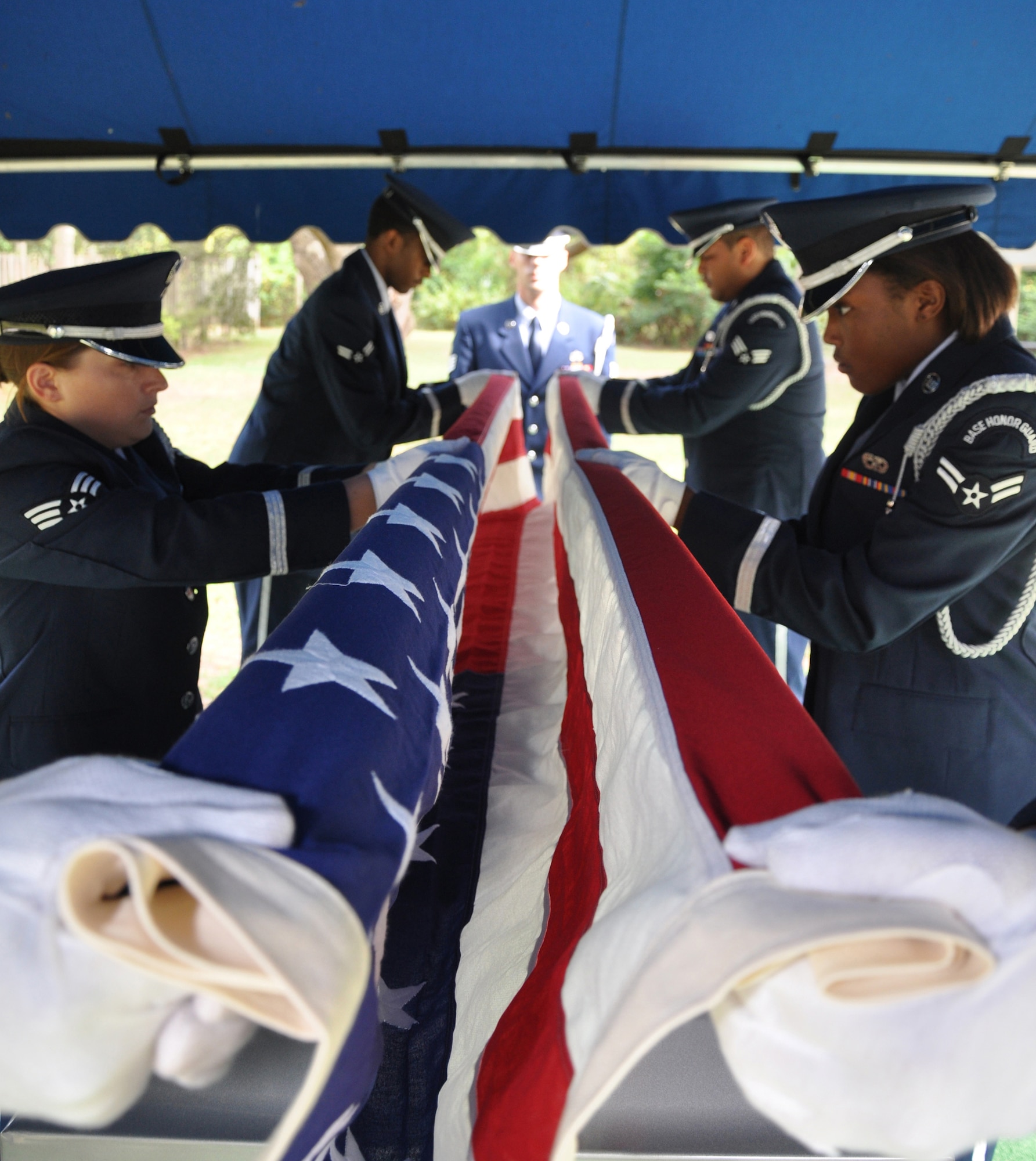 EGLIN AIR FORCE BASE, Fla. -- Staff Sgt. Thomas Rohr, NCOIC of funeral detail, watches as the Eglin Honor Guard pallbearers fold the flag during a standard funeral detail practice Oct. 17. The honor guard flight performed duties in 181 funerals in the past 12 months. (U.S. Air Force photo by Airman 1st Class Anthony Jennings)