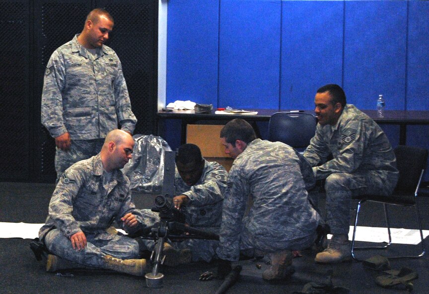 Security forces Airmen at the U.S. Air Force Expeditionary Center for training learn how to take apart and put back together a .50 caliber machine gunduring training in the center on Fort Dix, N.J., Oct. 23, 2008.  The Airmen were training for upcoming deployments to the Southwest Asia deployment theater of operations.  (U.S. Air Force Photo/Tech. Sgt. Scott T. Sturkol)