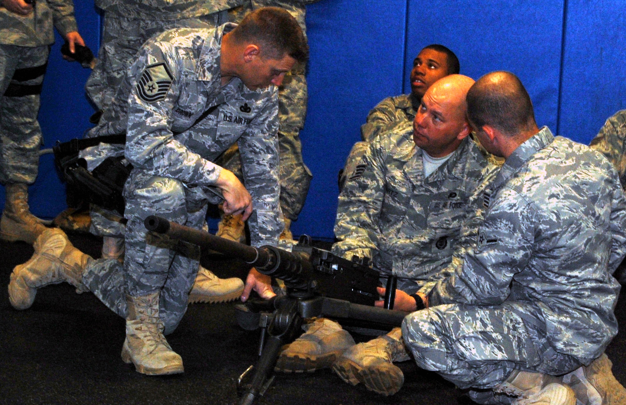 Security forces Airmen at the U.S. Air Force Expeditionary Center for training learn how to take apart and put back together a .50 caliber machine gun during training in the center on Fort Dix, N.J., Oct. 23, 2008.  The Airmen were training for upcoming deployments to the Southwest Asia deployment theater of operations.  (U.S. Air Force Photo/Tech. Sgt. Scott T. Sturkol)