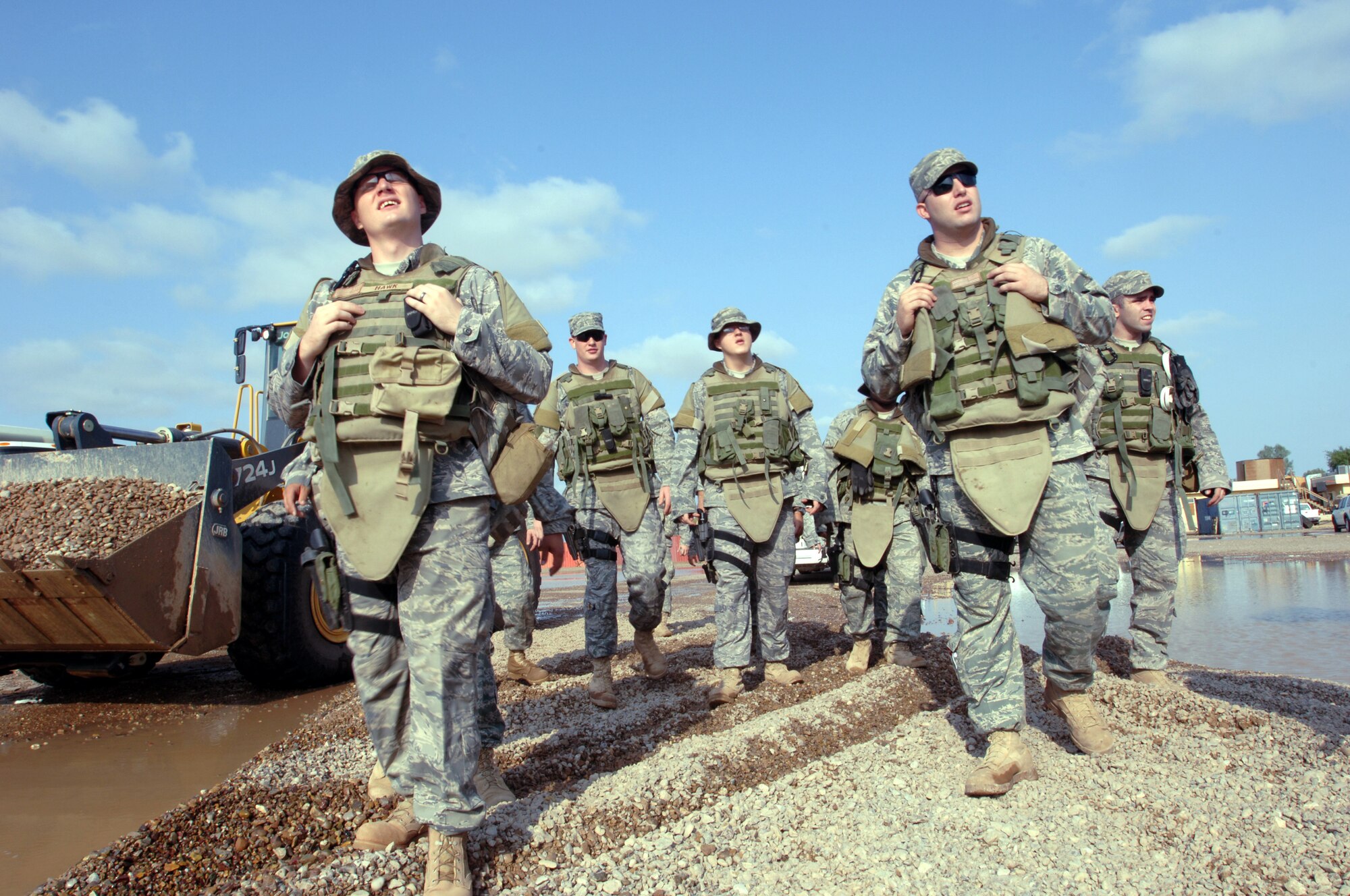 Airmen with the 532nd Security Forces Squadron look at construction equipment as they walk across a newly made path through a flooded area Oct. 25 at Joint Base Balad, Iraq. Because rain is infrequent in Iraq, when it does rain, the hardened ground soaks up little water. (U.S. Air Force photo/Tech. Sgt. Erik Gudmundson) 
