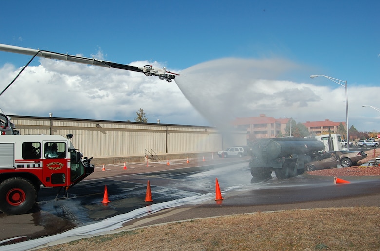 A Fire apparatus from the Peterson Fire Department makes safe the scene of a mock crash and fuel spill during the 21st Space Wing’s Condor Crest exercise Oct. 21. (Air Force photo/Corey Dahl) 