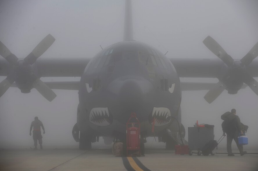 MOODY AIR FORCE BASE, Ga. – Airmen perform maintenance on an HC-130P Hercules aircraft during inclement weather Oct. 16 here. Despite thick fog, 71st Rescue Squadron and 723rd Aircraft Maintenance Squadron Airmen carried on their tasks as usual. (U.S. Air Force photo by Senior Airman Brittany Barker)