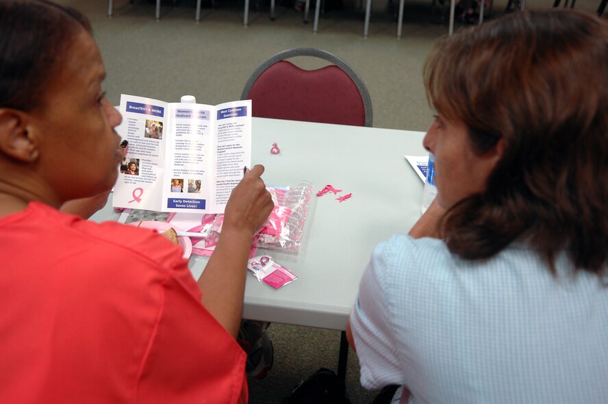 MOODY AIR FORCE BASE, Ga. – Shelia Davis-Wherry and Denise Smiley, 23rd Medical Group Women’s Health Clinic, discuss breast cancer awareness information Oct. 22 here. Mrs. Wherry and Ms. Smiley both worked booths around base to promote breast cancer awareness. (U.S. Air Force photo by Airman Joshua Green)
