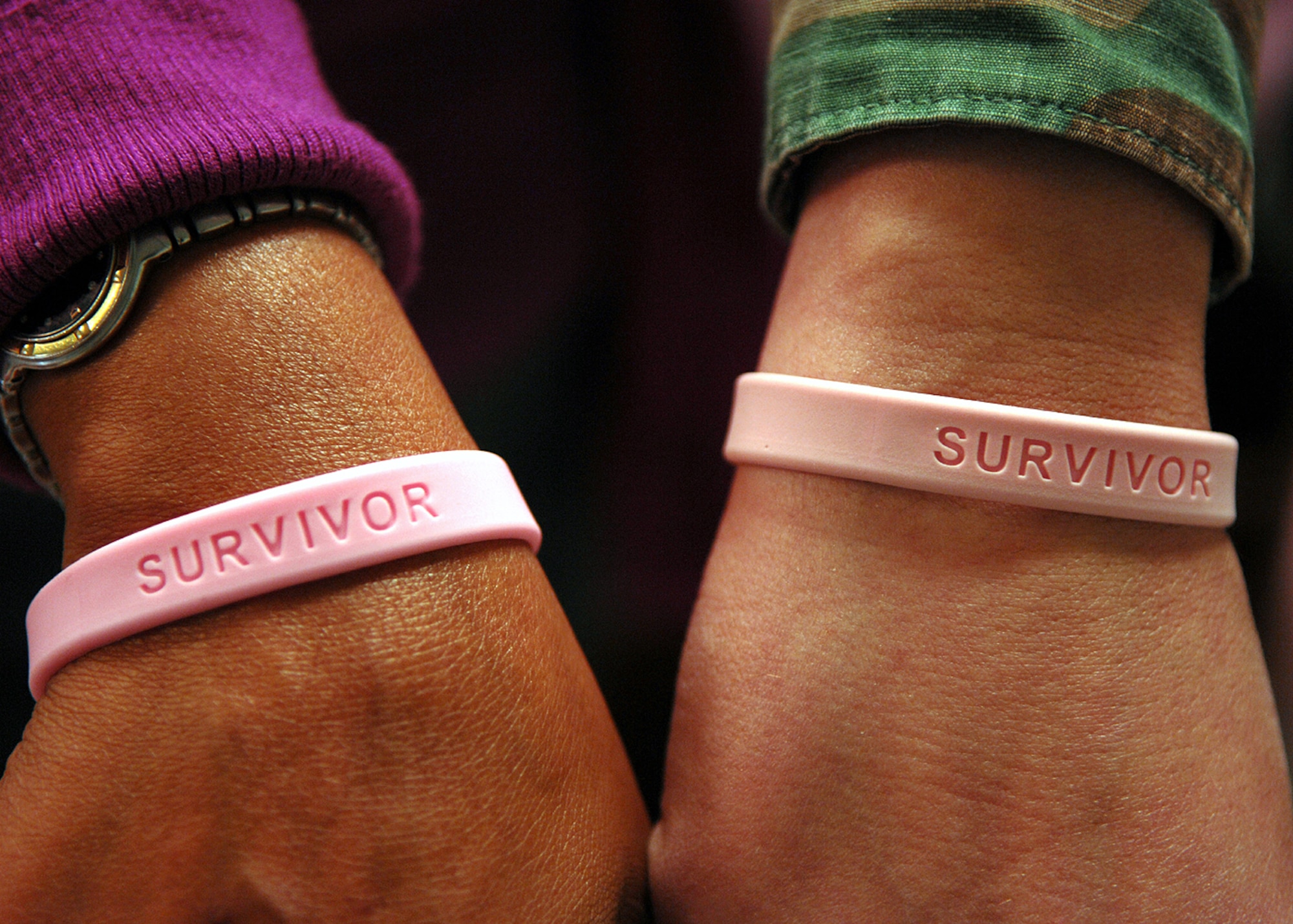 MOODY AIR FORCE BASE, Ga. – Two co-survivors display their bracelets to show support for breast cancer awareness. A co-survivor is a person who helped a relative or friend during a bout with breast cancer. (U.S. Air Force photo by Airman Joshua Green) 