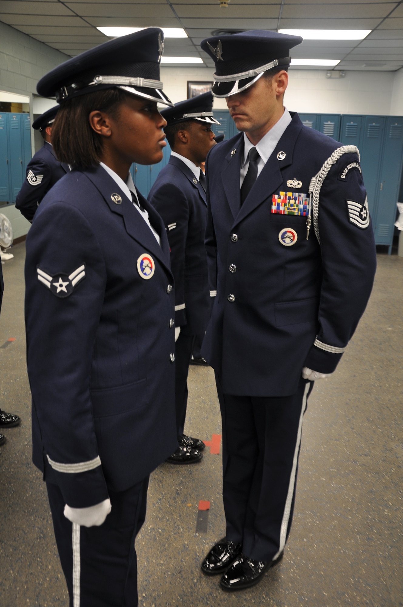 EGLIN AIR FORCE BASE, Fla. -- Tech. Sgt. Troy Kiick, Eglin Honor Guard NCOIC, inspects the uniform of Airman 1st Class Brittany Polk, a senior honor guard member. The uniform inspections take place before the honor guard members report to perform at a ceremony, along with other preparations such as a dress rehearsal. (U.S. Air Force photo by Airman 1st Class Anthony Jennings)