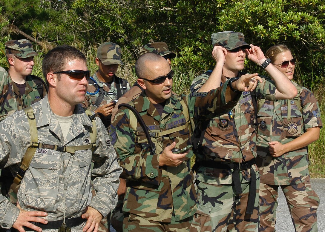 KADENA AIR BASE, Japan -- Master Sgt. Christopher Juarez, 353rd Operations Support Squadron, points to a landmark between waypoints during a basic land navigation course Oct. 24 at a training site near here. Participants learned basic principles of land navigation including map reading, how to use a compass, and pace counting during the training. About 12 members of the 353rd Special Operations Group and 18th Wing participated in the course. (U.S. Air Force photo by Tech. Sgt. Aaron Cram)                                