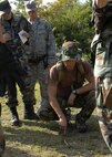 KADENA AIR BASE, Japan -- A Survival, Evasion, Resistance and Escape specialist assigned to the 353rd Operations Support Squadron, discusses how to navigate around an impassible obstacle during a basic land navigation course Oct. 24 at a training site near here. Participants learned basic principles of land navigation including map reading, how to use a compass, and pace counting during the training. About 12 members of the 353rd Special Operations Group and 18th Wing participated in the course.  (U.S. Air Force photo by Tech. Sgt. Aaron Cram)                                