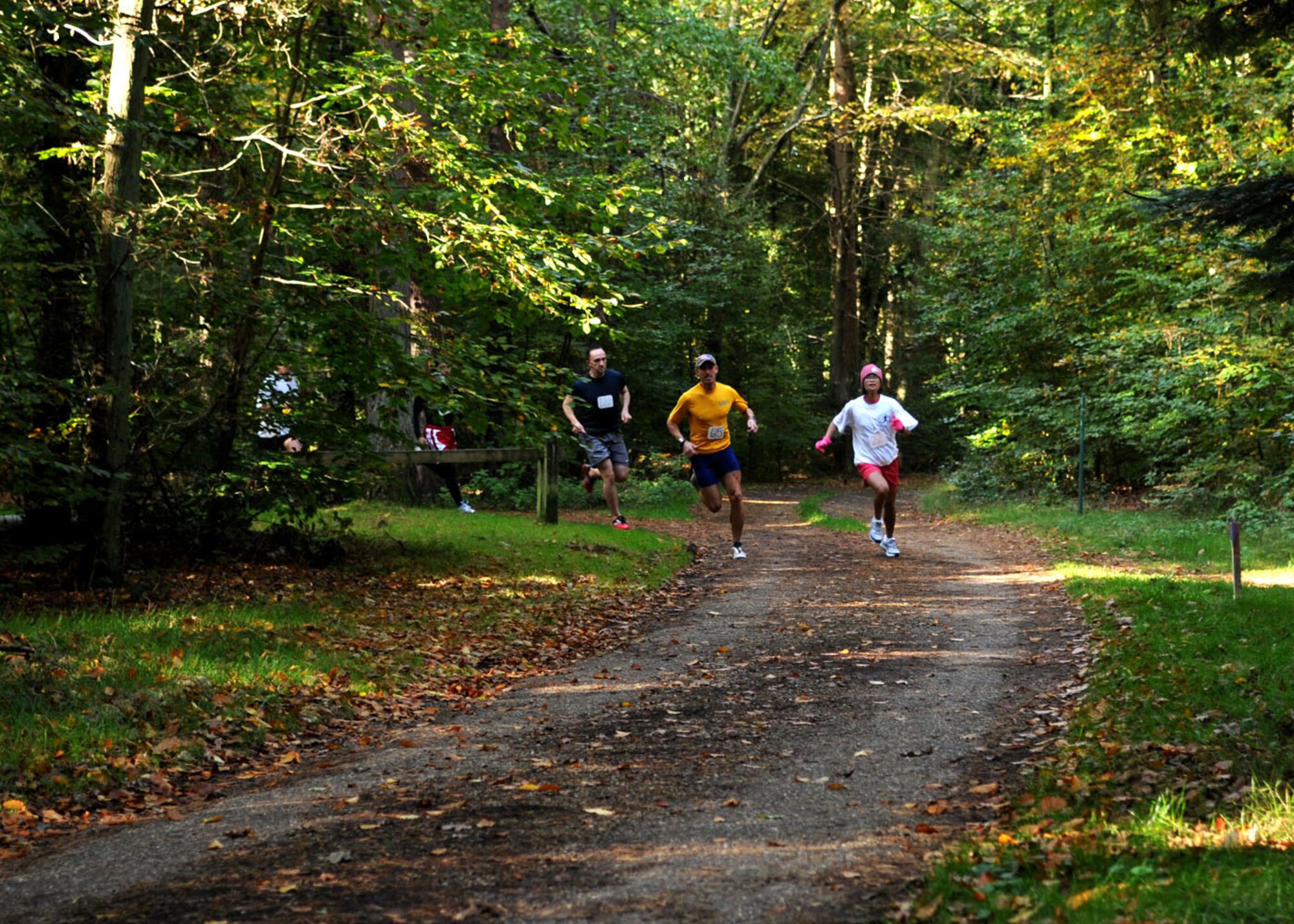 Dan Avondoglio and Senior Airman Trasy Rincan lead the pack during the 5K run for the “United States Air Force Europe Cross Country Regional’s in Brandon, England, Oct. 18, 2008. The 100th Services Squadron held the event to promote fitness and camaraderie and to give qualifying runners the opportunity to participate in the finals held in Poland. (U.S. Air Force photo by Staff Sgt. Jerry Fleshman)