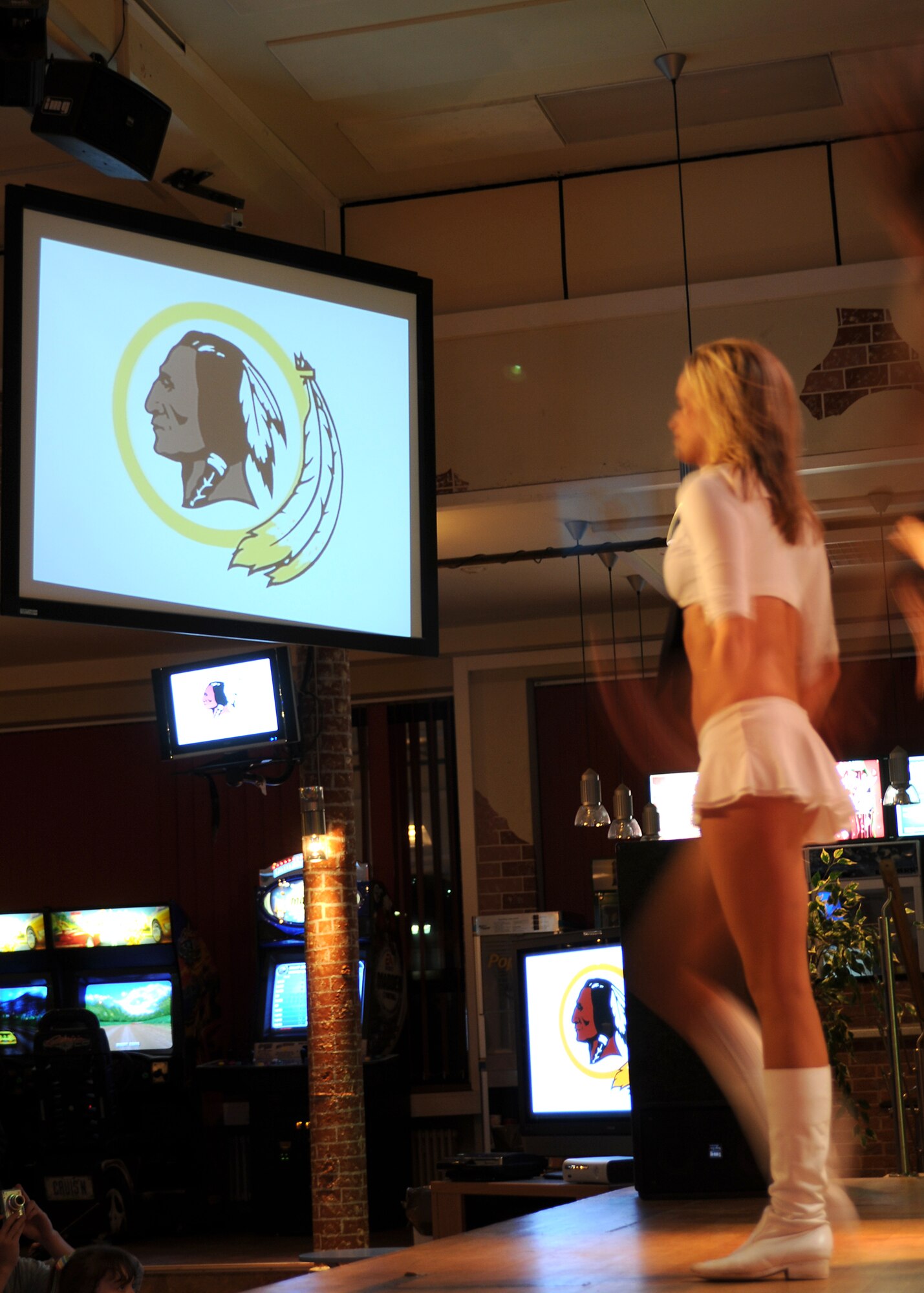 A cheerleader from the Washington Redskins National Football League team dances on the stage of the Brick House on Spangdahlem Air Base, Oct. 6. This Tour was the 27th overall for the Washington Redskins Cheerleaders and the 25th for the director of entertainment and cheerleading for the organization.