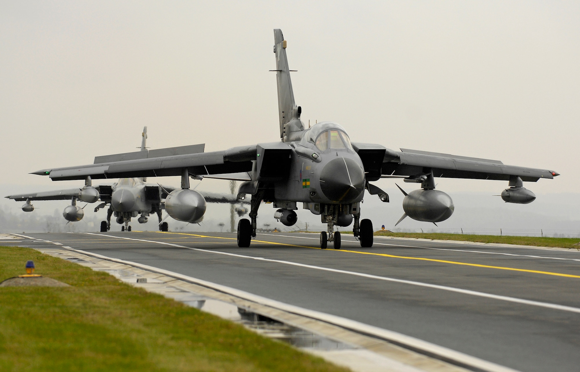 SPANGDAHLEM AIR BASE, Germany – Two Royal Air Force Tornado GR4 bombers taxi down Spangdahlem’s runway Oct. 22, 2008. The aircraft and support units from the 9th Bomber Squadron, RAF Marham, were taking place in a two-week excerise to provide integration between British air and land forces.  (Courtesy Photo)