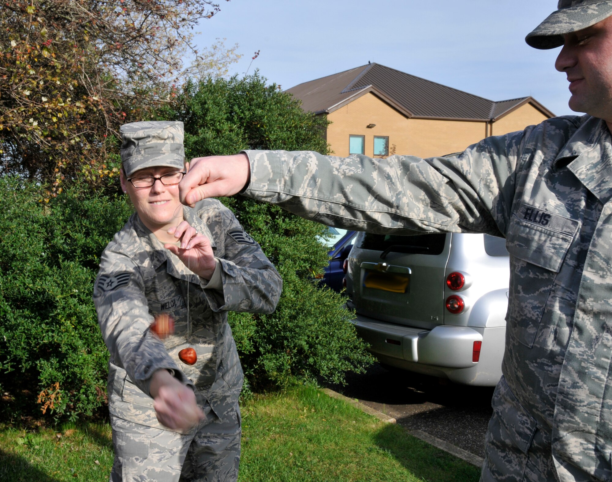 Staff Sgt Felicia Welch and Senior Airman Brian Ellis engage in a game of conkers. The game is played between two players taking turns striking their opponent’s conker with their own. The intent is to hit the opponent’s conker as hard as possible, inflicting damage on your opponent.The first recorded game of conkers dates back to 1848 on the Isle of Wight. 

Conkers are hard brown nuts found in a prickly case that fall from the tree when ripe. The origin of the name 'conker' is unclear but it's believed that it comes from the French word 'cogner' meaning to hit. ( Photo by A1C Perry Aston)