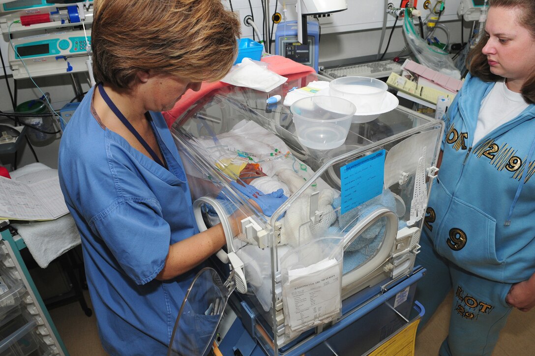 Staff Nurse Jane Foster, Norfolk and Norwich University Hospital NeoNatal Unit, performs a heel prick test on Eric Frazier Oct. 21, as his mother Mandy Frazier looks on. Eric and his twin sister Alexis were born prematurely at 23 weeks gestational period, Sept. 6. Their due date was Jan. 1, 2009. Staff Nurse Foster is one of the hospital staff caring for the babies on the neonatal ward at the British hospital. A heel prick test, done to check different levels in the blood, is just one of the tests the babies have on a regular basis. (U.S. Air Force photo by Karen Abeyasekere)