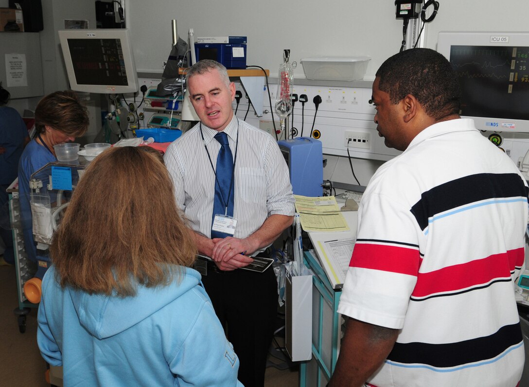 Dr. Paul Clarke, center, consultant neonatologist at the Norfolk and Norwich University Hospital, talks with parents Mandy, left, and Tech. Sgt. Barry Frazier, 100th Air Refueling Wing Legal Office. The Fraziers have twin babies born four months premature. Aged almost 7 weeks, they still each weigh less than a regular bag of sugar. (U.S. Air Force photo by Karen Abeyasekere)