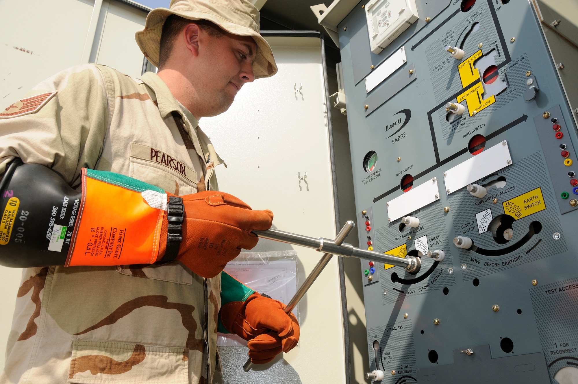SOUTHWEST ASIA -- Tech. Sgt. Kevin Pearson, electrical systems craftsman from the 380th Expeditionary Civil Engineer Squadron, de-energized and grounded a transformer here Oct. 20. Sergeant Pearson donned high voltage rubber gloves before attempting to work on the electrical equipment. He was working on the transformer that powered half the base communication area. Sergeant Pearson is deployed from the 52nd CES Spangdhalem Air Base, Germany His hometown is Casper, Wyo. (U.S. Air Force photo/Tech. Sgt. Christopher A. Campbell)(released)
