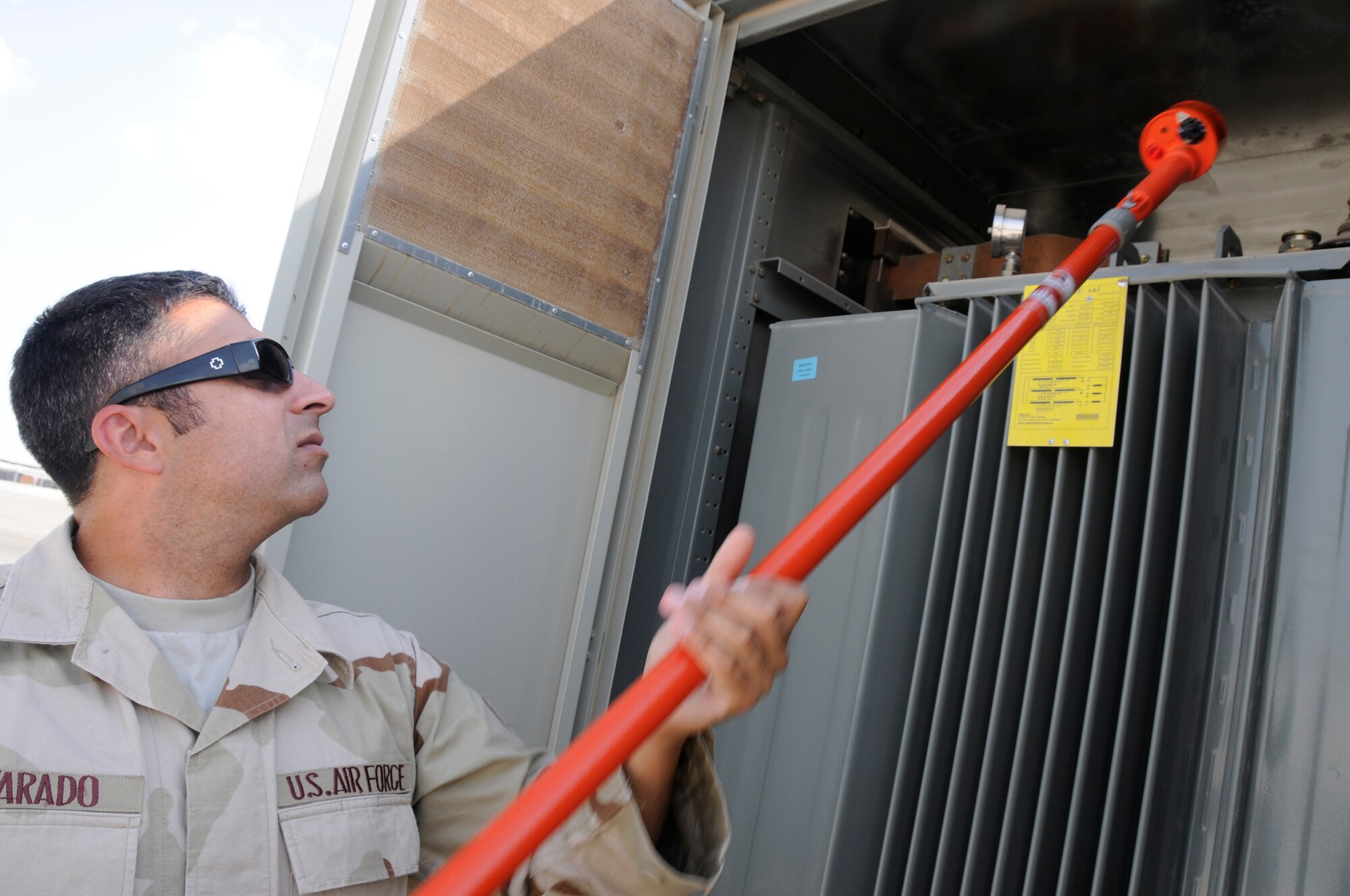 SOUTHWEST ASIA -- Tech. Sgt. Daniel Alvarado, noncomissiined officer-in-charge of the electrical systmes flight from the 380th Expeditionary Civil Engineer Squadron, used a high voltage phase indicator here Oct. 20. The voltage indicator is used to test for the presence of voltage before attempting to work on the electrical equipment. Sergeant Alvarado is deployed from the 36th CES Anderson Air Force Base, Guam. His hometown is Santa Barbara, Calif. (U.S. Air Force photo/Tech. Sgt. Christopher A. Campbell)(released)