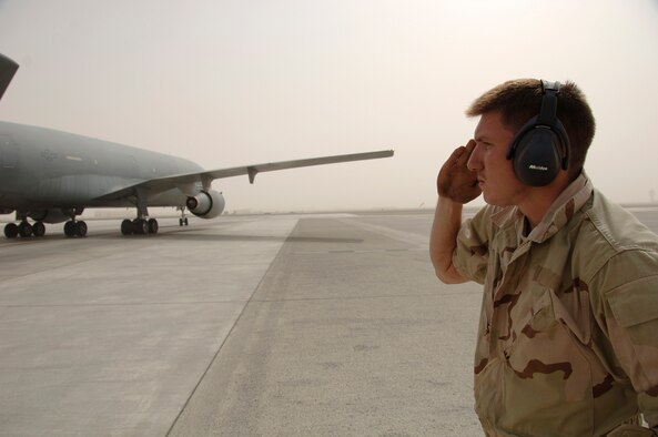 Senior Airman William Brigham from the 380th Expeditionary Aircraft Maintenance Squadron renders a salute to a KC-10 here. This is one of the procedures for the maintenance personnel to perform during the takeoff of an aircraft.  The KC-10's, out of the 380th, provide gas to all aircraft flying in the Area of Responsibility in support of the war on terrorism. Airman Brigham is deployed from the 660th AMXS Travis Air Force Base, Calif., his hometown is Eatonville, Wash. (U.S. Air Force photo/Tech. Sgt. Christopher A. Campbell)(released)