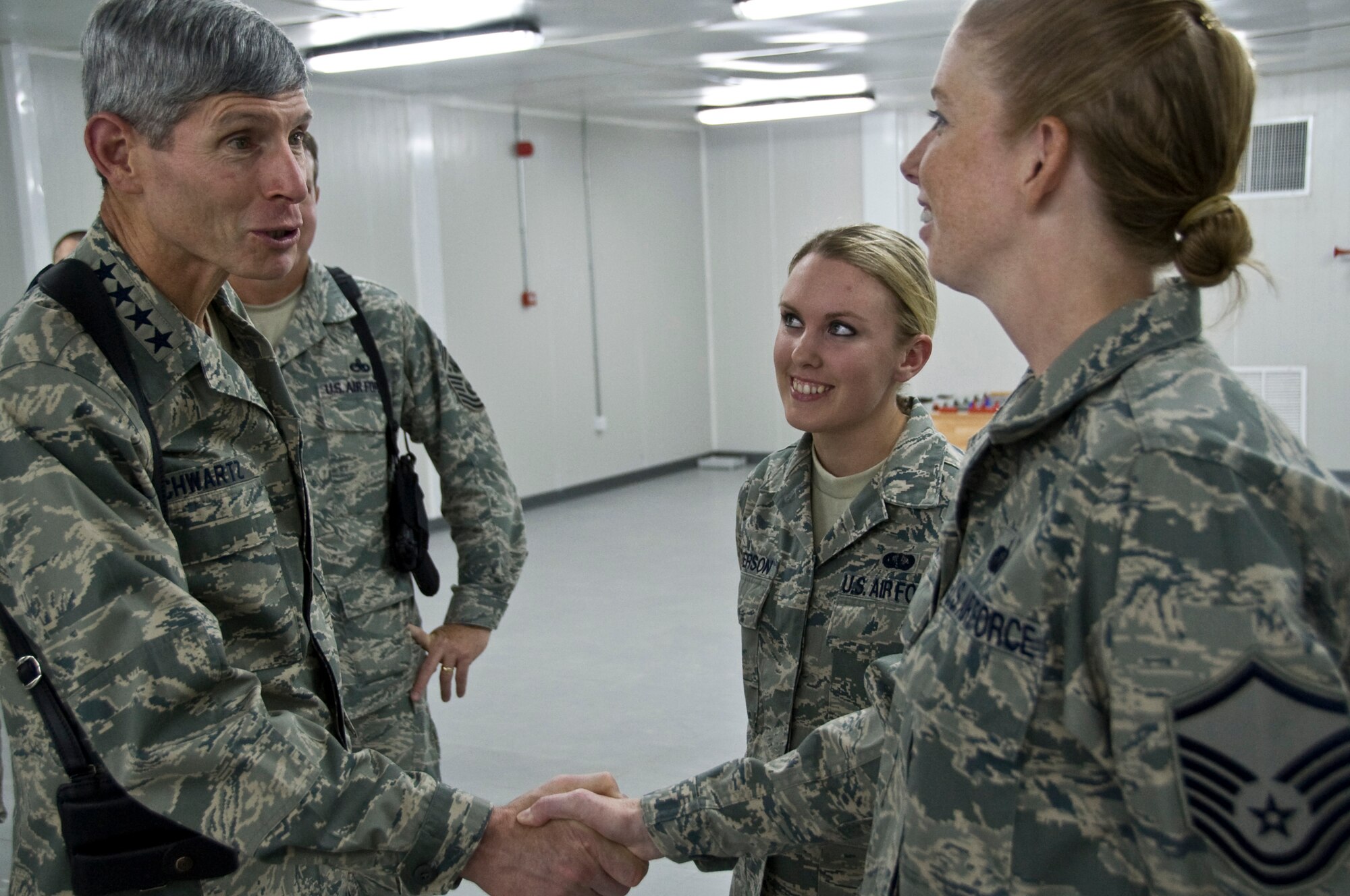 ALI BASE, Iraq -- Air Force Chief of Staff Gen. Norton Schwartz greets Master Sgt. Linda Nelson and Senior Airman April Severson, 407th Expeditionary Force Support Squadron, during a visit here Oct. 24. General Schwartz and Chief Master Sergeant of the Air Force Rodney McKinley visited with Airmen in the 407th Air Expeditionary Group and toured facilities during a stop here. The visit marked the CSAF's first trip to the U.S. Air Forces Central area of responsibility since his appointment as the Air Force chief of staff. (U.S. Air Force photo/Senior Airman Christopher Griffin)