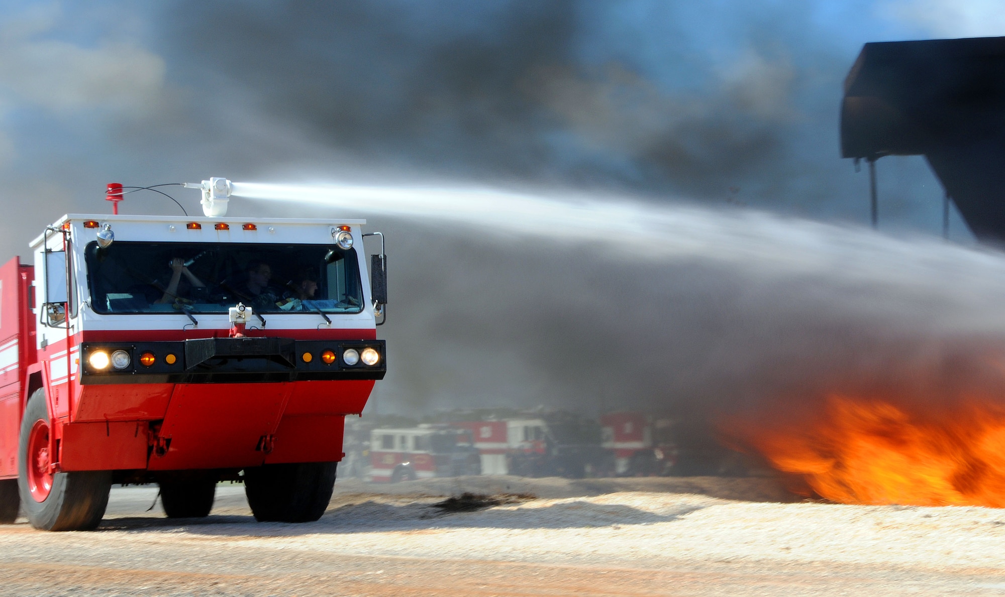 ANDERSEN AIR FORCE BASE, Guam -  Members of the 36th Civil Engineer Squadron Fire and Emergency Services Flight put out a controlled fire during this quarter's live fire training here Oct. 24. Fire fighters participate in quarterly training to sharpen up their skills for real world situations. (U.S. Air Force photo by Airman 1st Class Courtney Witt)