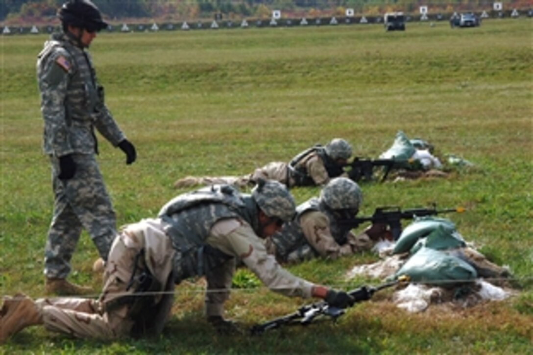 U.S. Navy Petty Officer 1st Class Steven Wotczak, center, high-crawls to cover during a bounding drill as part of Joint Services Training Operations 10 on Camp Attebury, Ind., Oct. 18, 2008. JSTO-10 is participating in a month-long training cycle with the U.S. Army preparing for deployment with Naval Special Warfare Command supporting Operation Iraqi Freedom. 